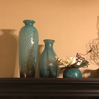 Turquoise vases with feather pattern on desk