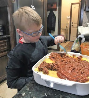 Noah helping Make Lasagna