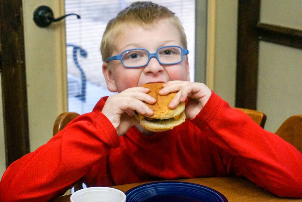 Cute Boy Enjoying Air Fryer Hamburger