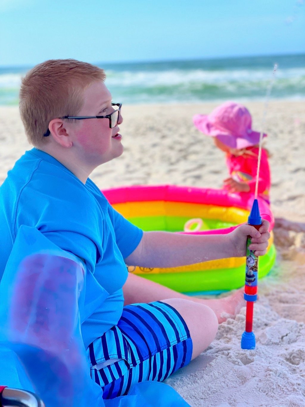 child with a full arm cast at the beach - cast cover