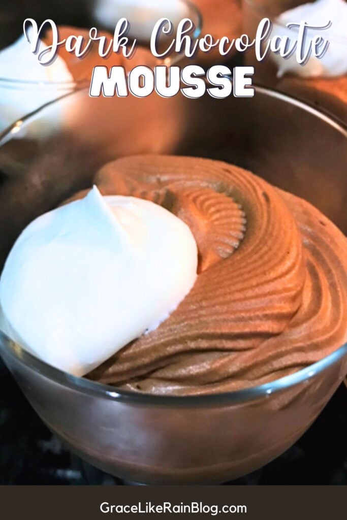 dark chocolate mousse in a glass serving dish with a dollop of whipped cream