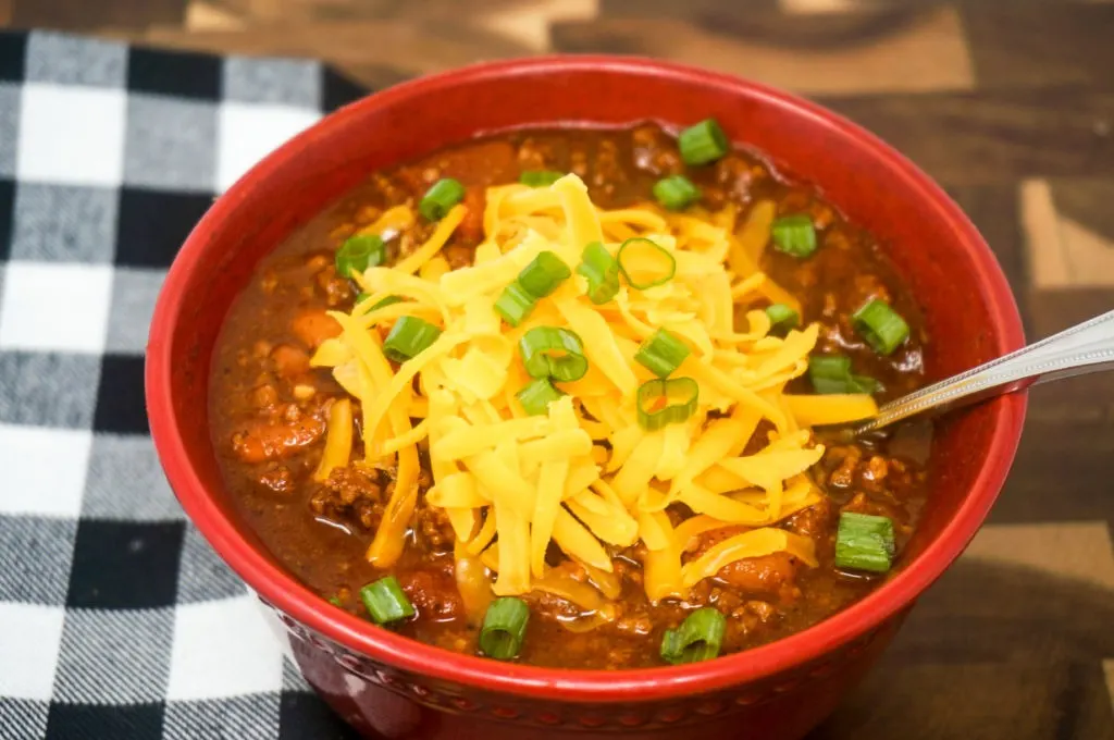 Bowl of Chili with cheese and green onions