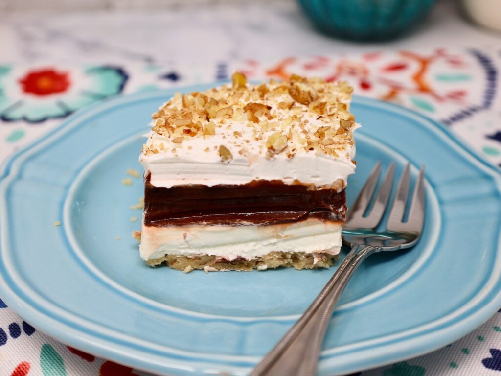 a thick slice of 4-layer delight, you can see layers of cream cheese, and chocolate pudding