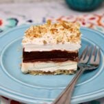 a thick slice of 4-layer delight, you can see layers of cream cheese, and chocolate pudding