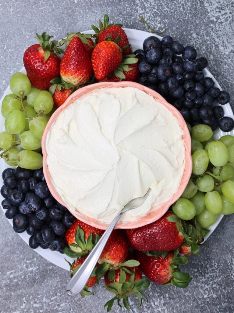 fruit dip in a pretty bowl surrounded by fresh fruit