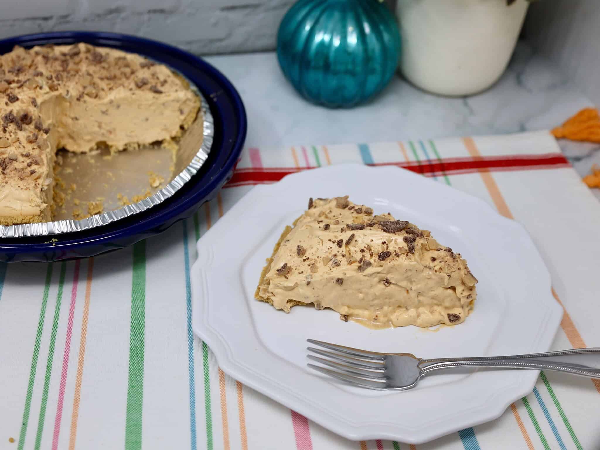 Easy no bake butterscotch pie on a white plate with graham cracker crust