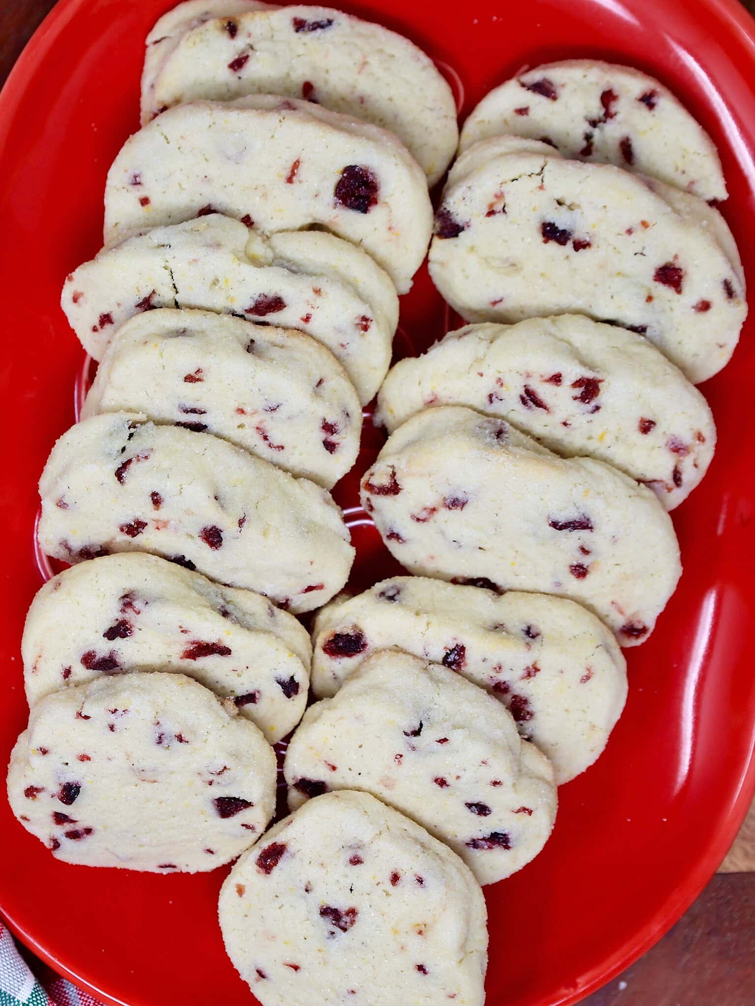 a plate of orange cranberry shortbread cookies