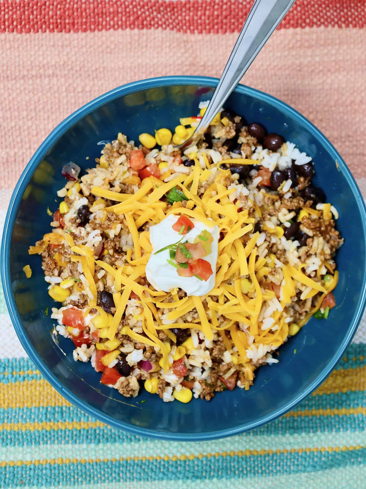 Build your own ground beef taco rice bowl with customizable toppings