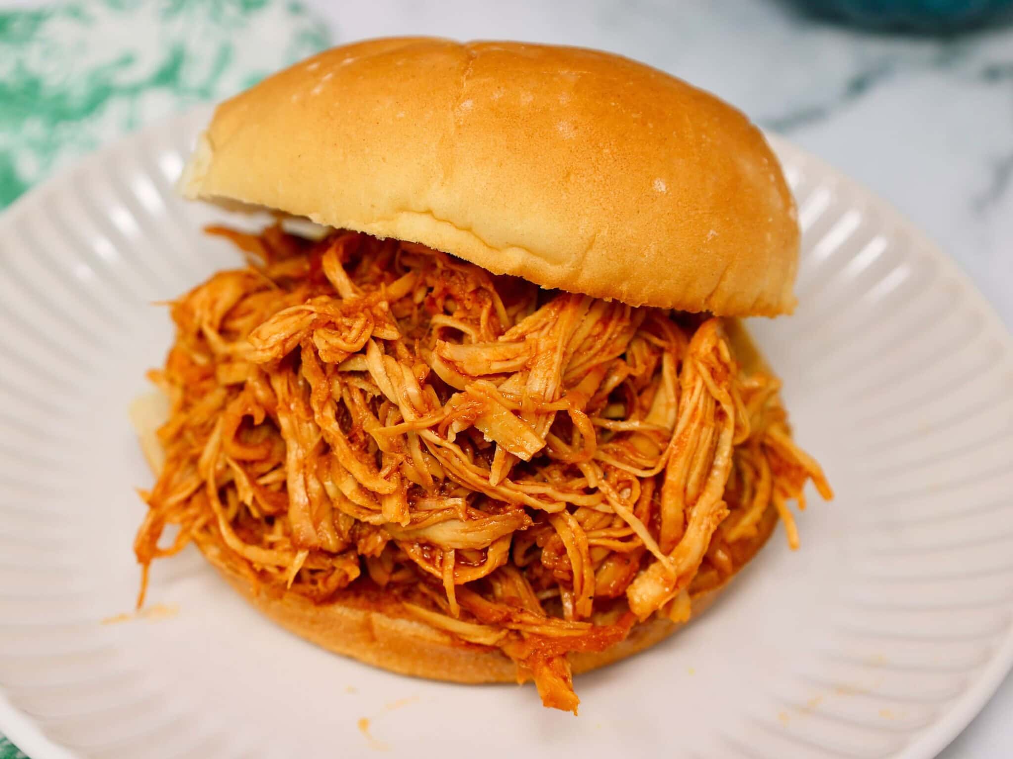 Slow cooker BBQ chicken sandwich made with tender shredded crockpot chicken