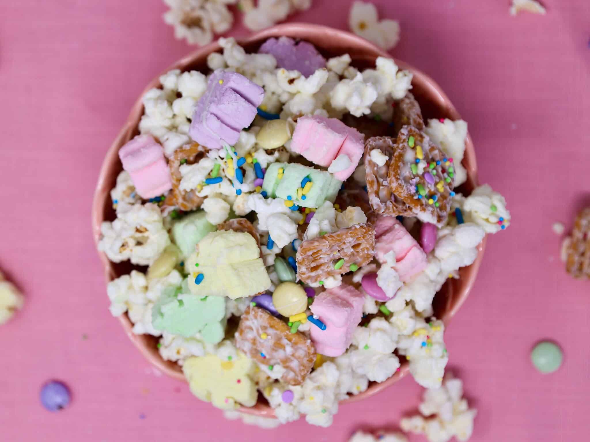 Mixing popcorn, pretzels, and marshmallows for no bake Easter popcorn snack mix