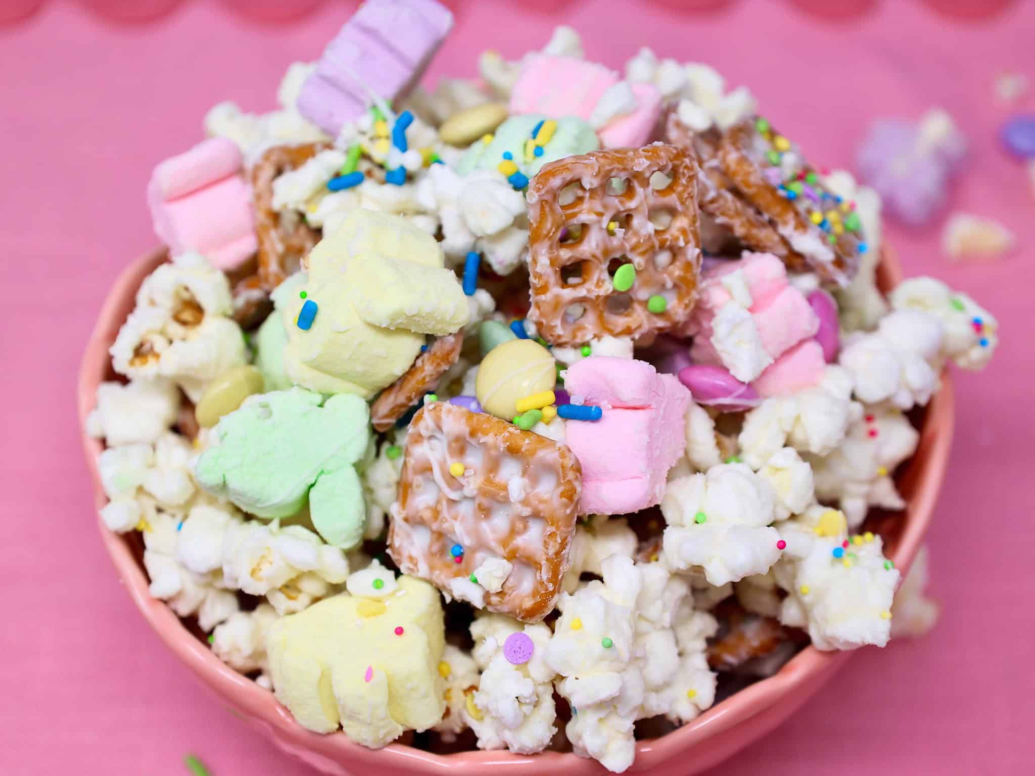 No bake Easter snack mix broken into clusters with pastel candy and sprinkles