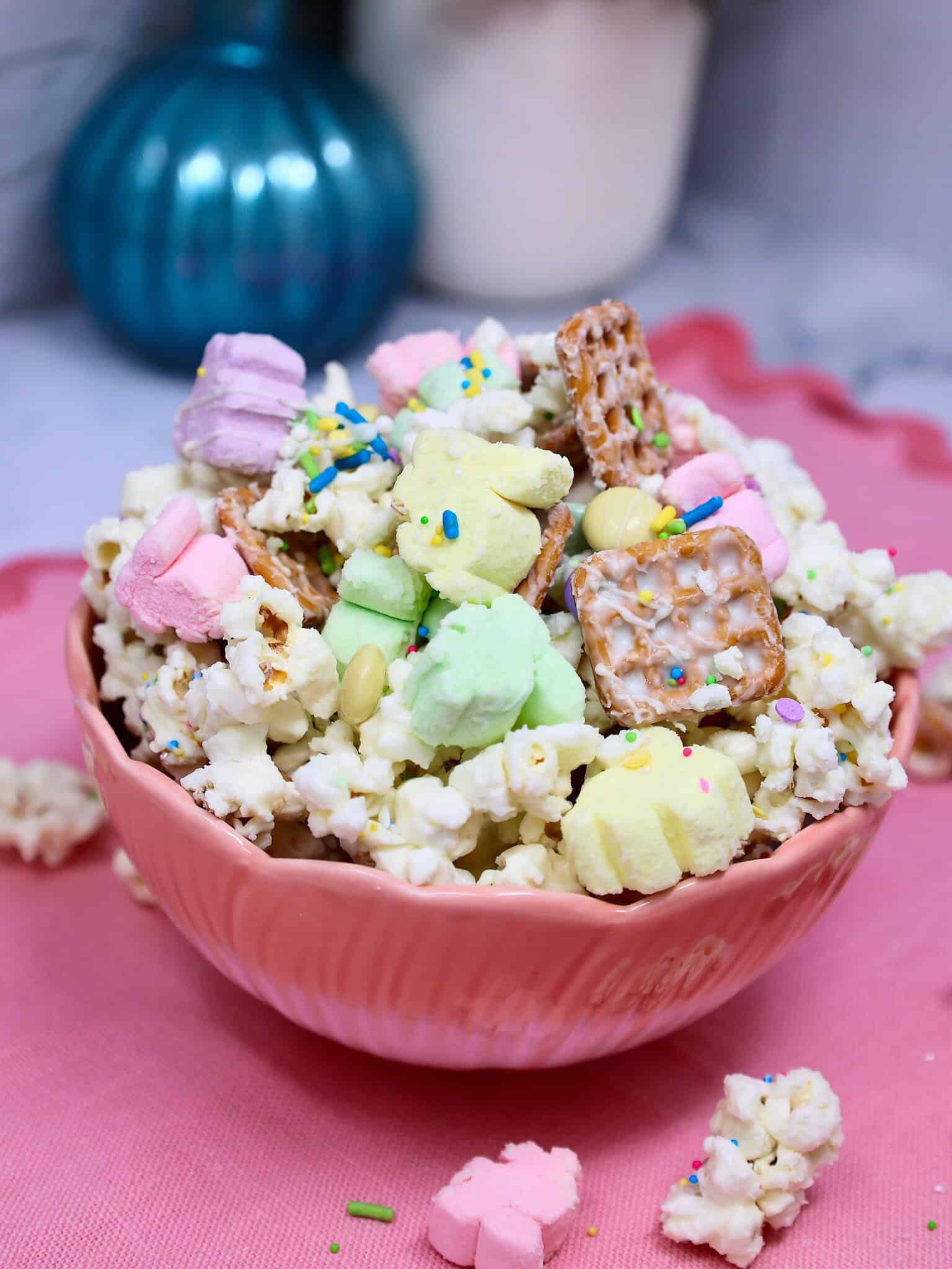 Easy no bake Easter popcorn snack mix recipe with popcorn, pretzels, marshmallows, white chocolate, and pastel M&Ms