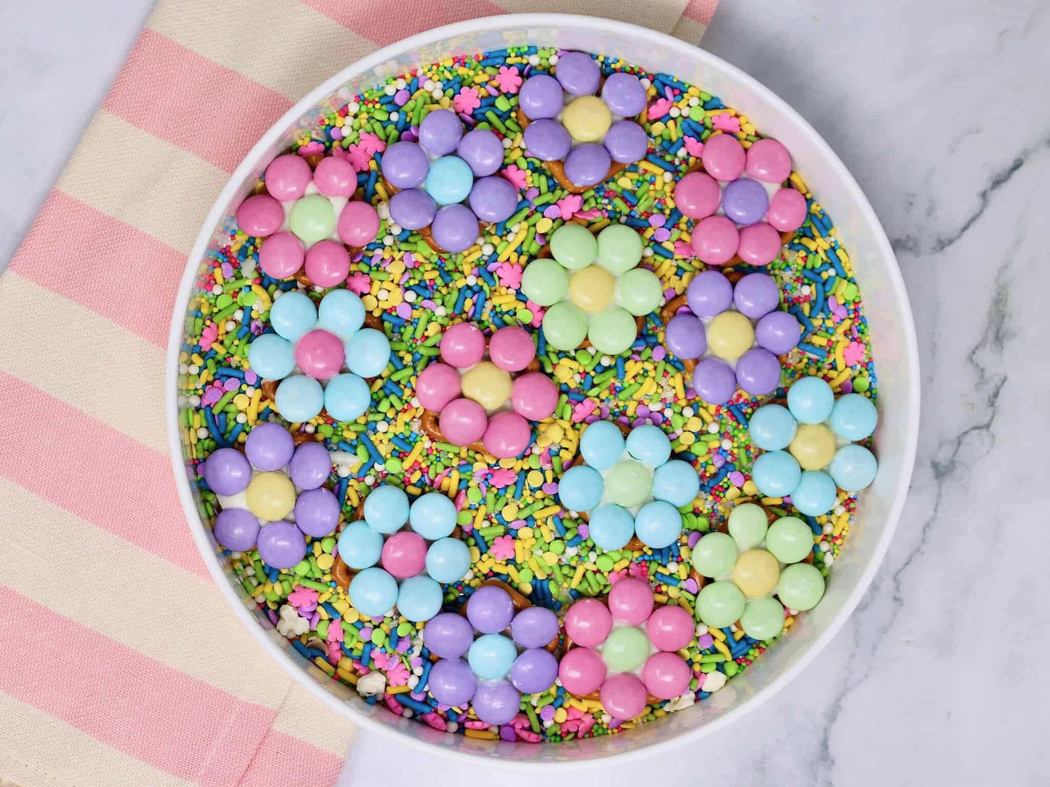 close up of Easter pretzel flowers with pastel M&Ms and white chocolate