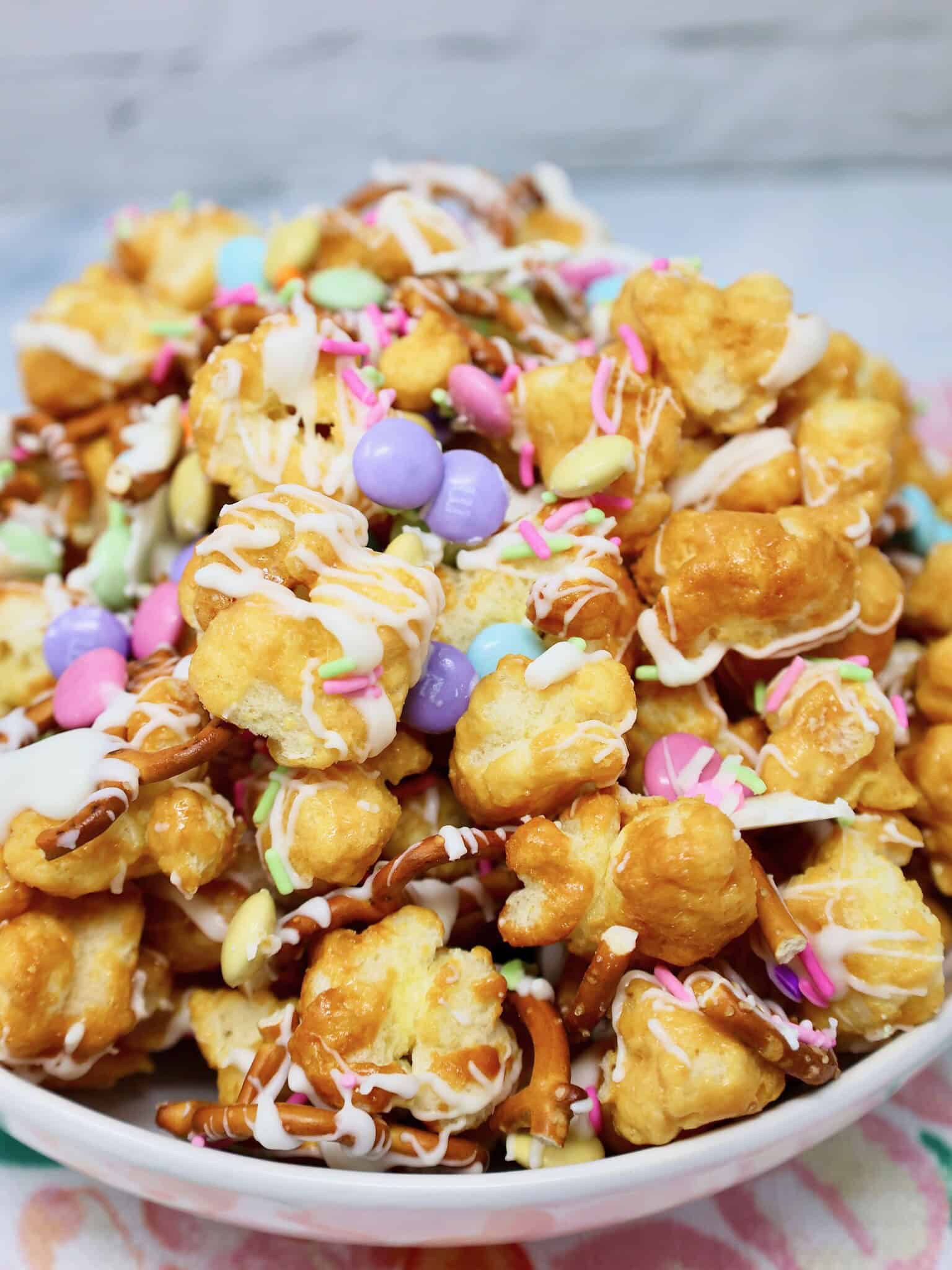 Easter puff corn snack mix with white chocolate drizzle and pastel spring M&M's