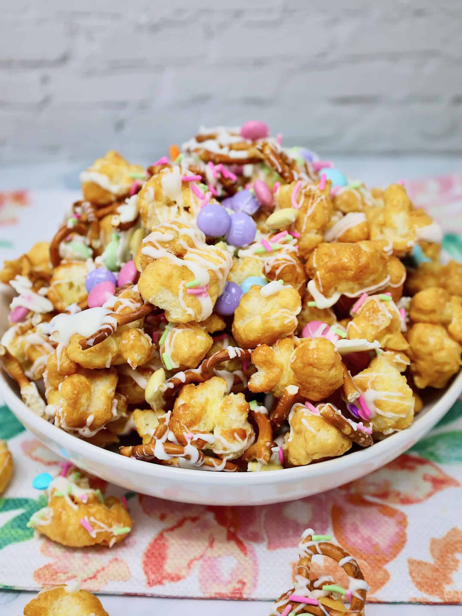 Bowl of Easter Puff Corn Crunch sweet and salty Easter snack mix with caramel puff corn and pastel candy
