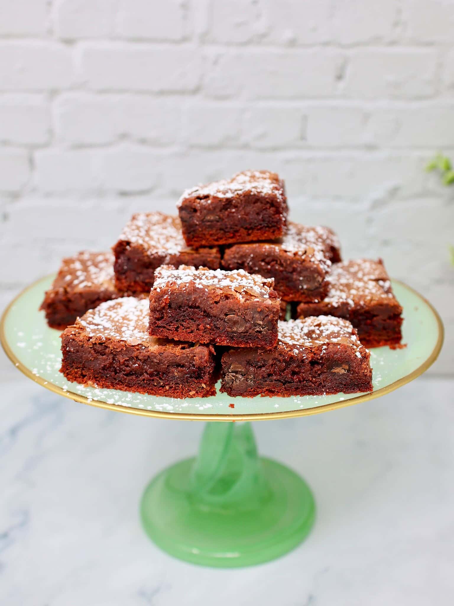 ingredients for red velvet gooey butter cake including cake mix, cream cheese, eggs and powdered sugar