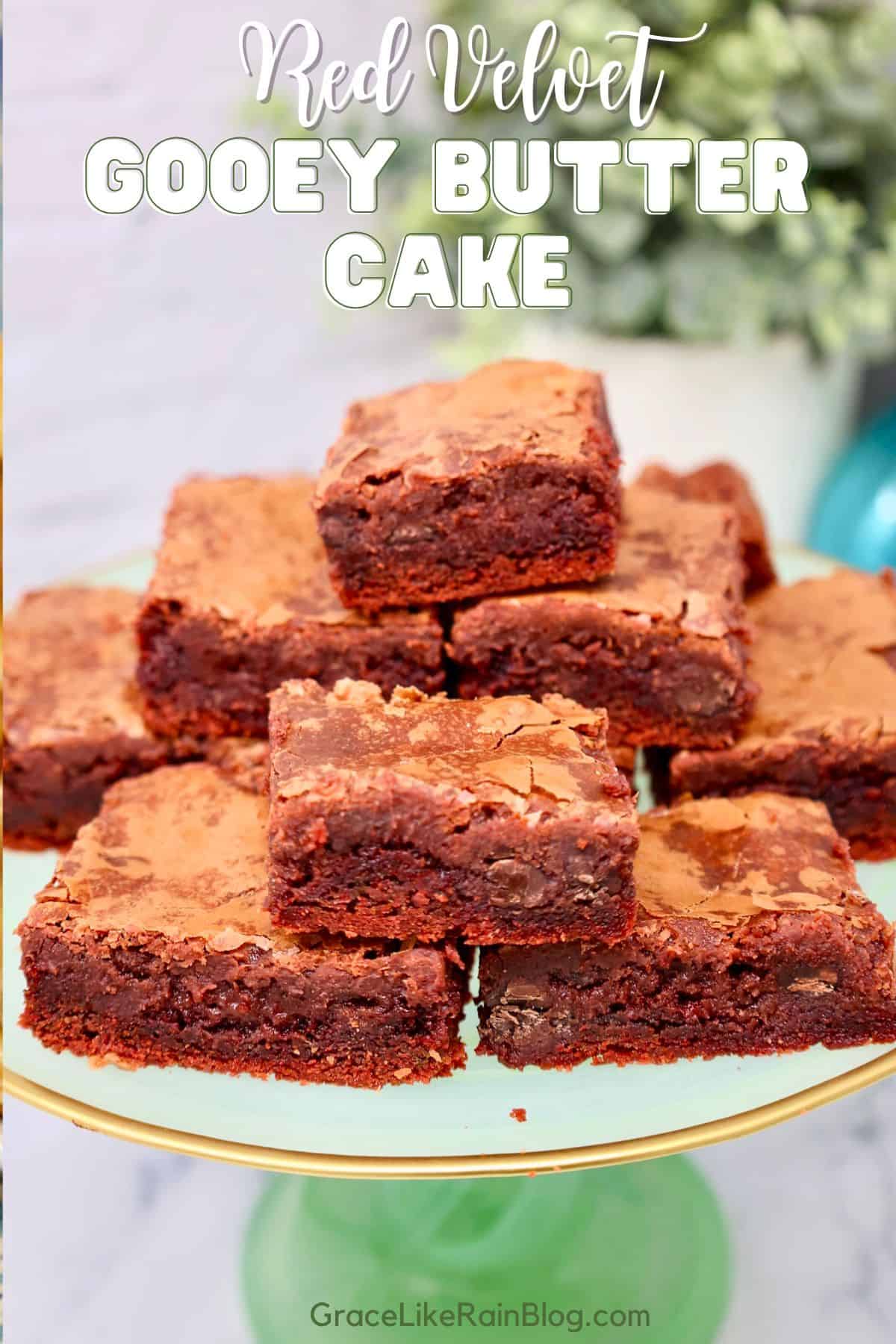 red velvet gooey butter cake bars dusted with powdered sugar in a glass baking dish