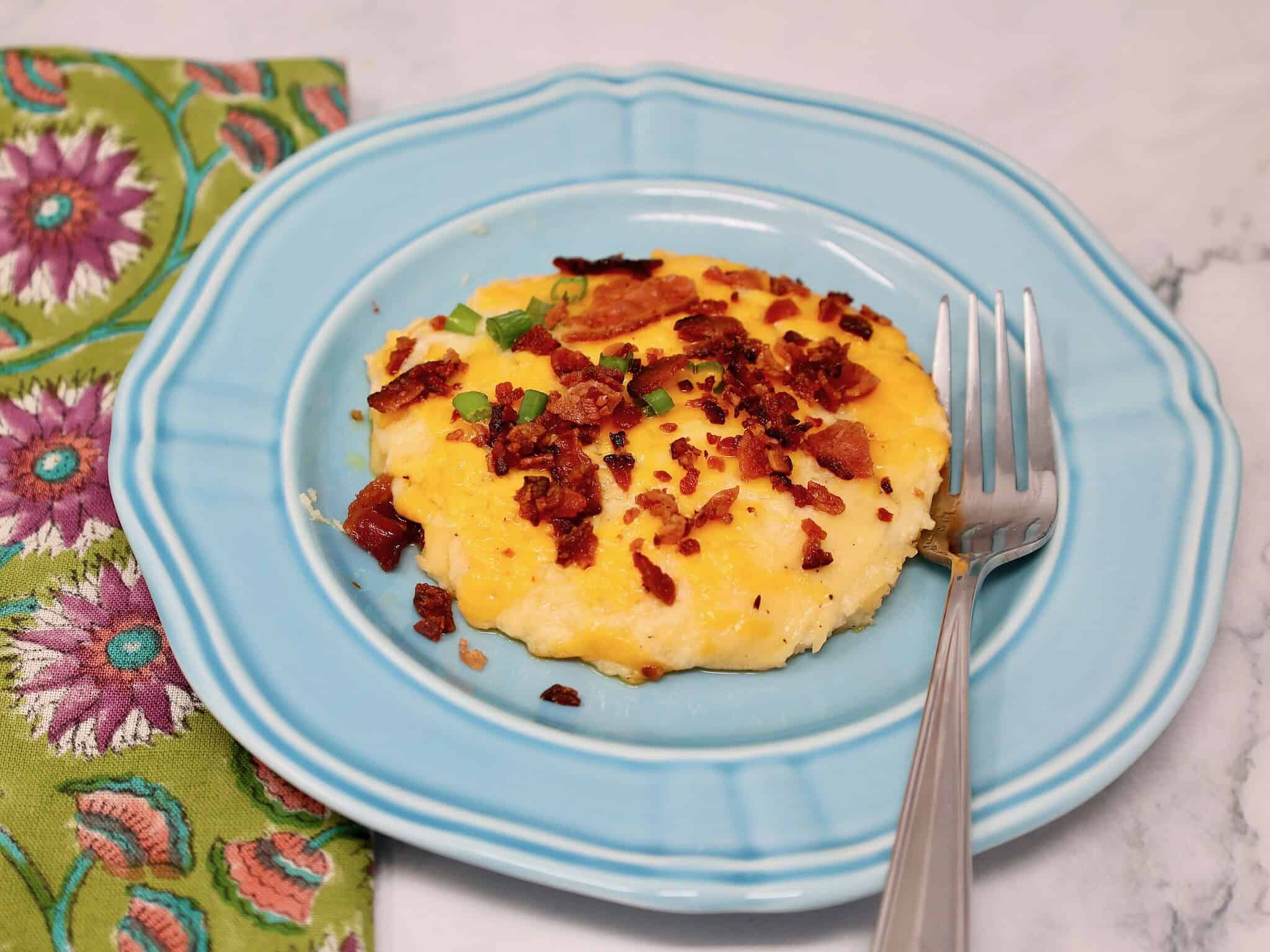 loaded cheesy mashed potato casserole with bacon and green onions