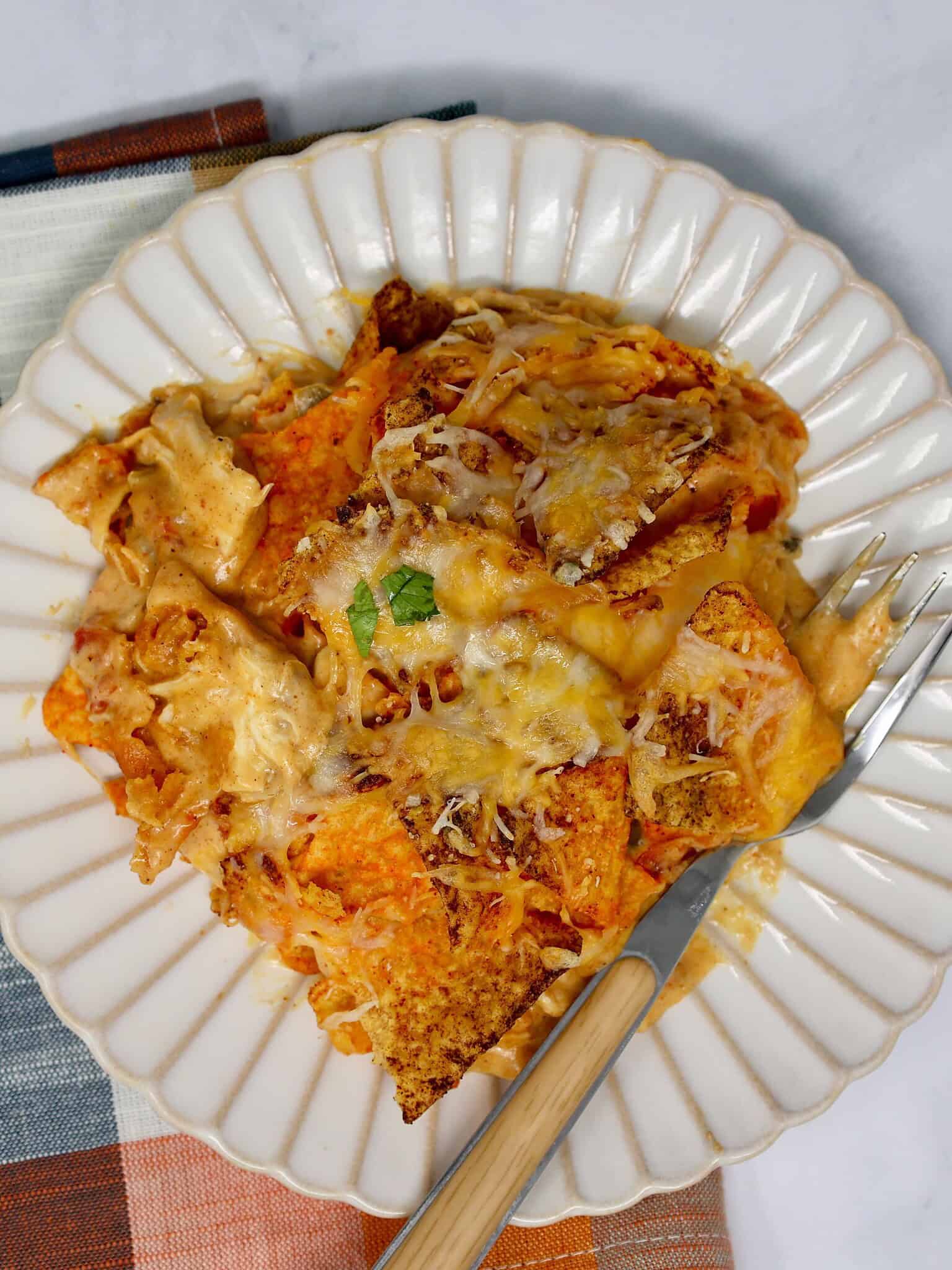 easy Doritos chicken casserole served on a plate with cheesy layers