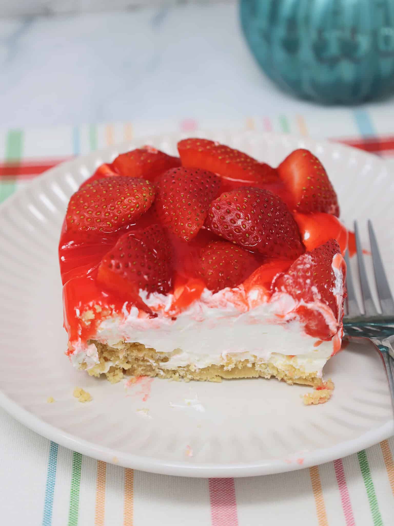 fresh strawberries and glaze topping layered dessert