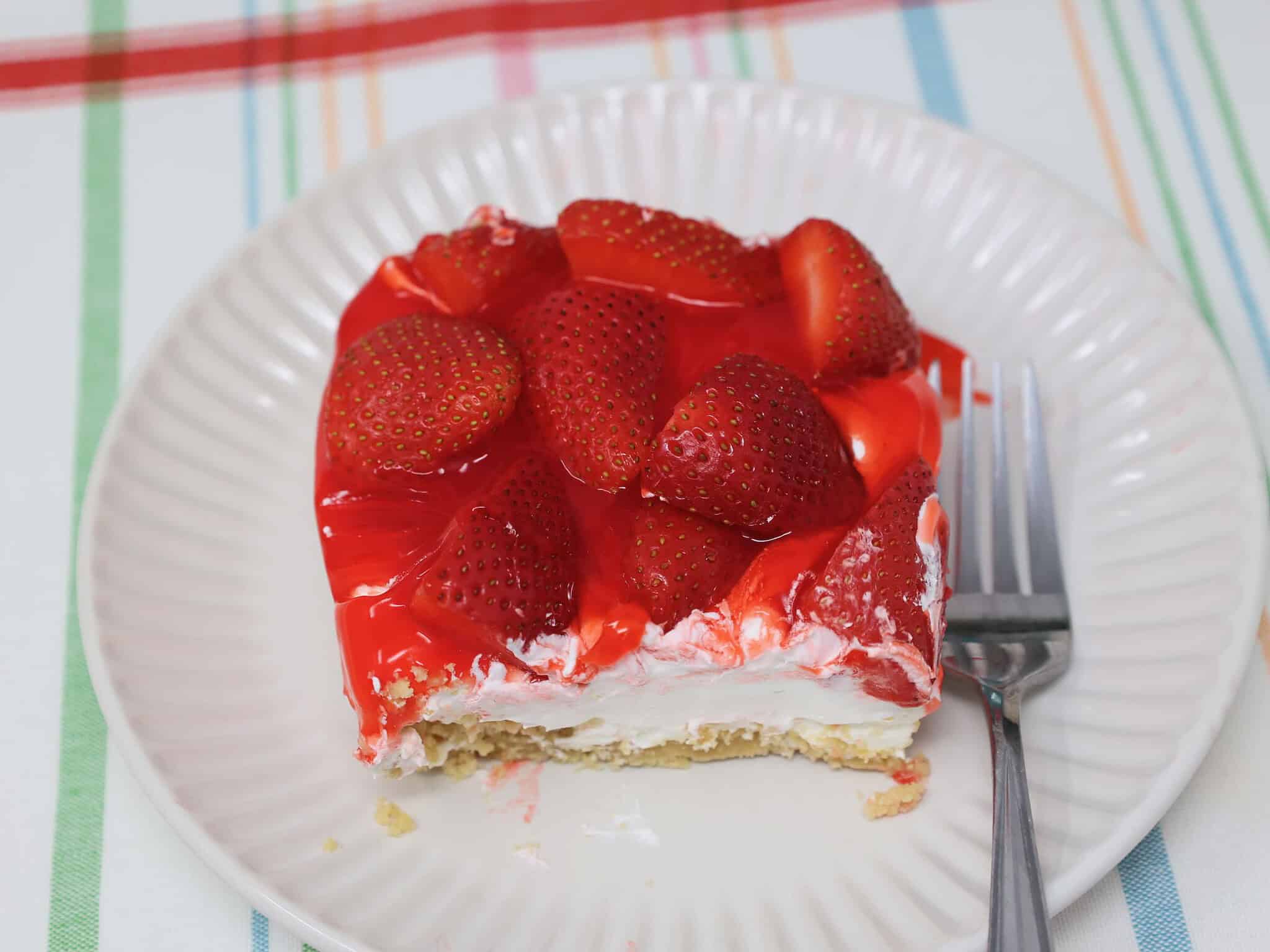 slice of no bake strawberry cheesecake delight on plate