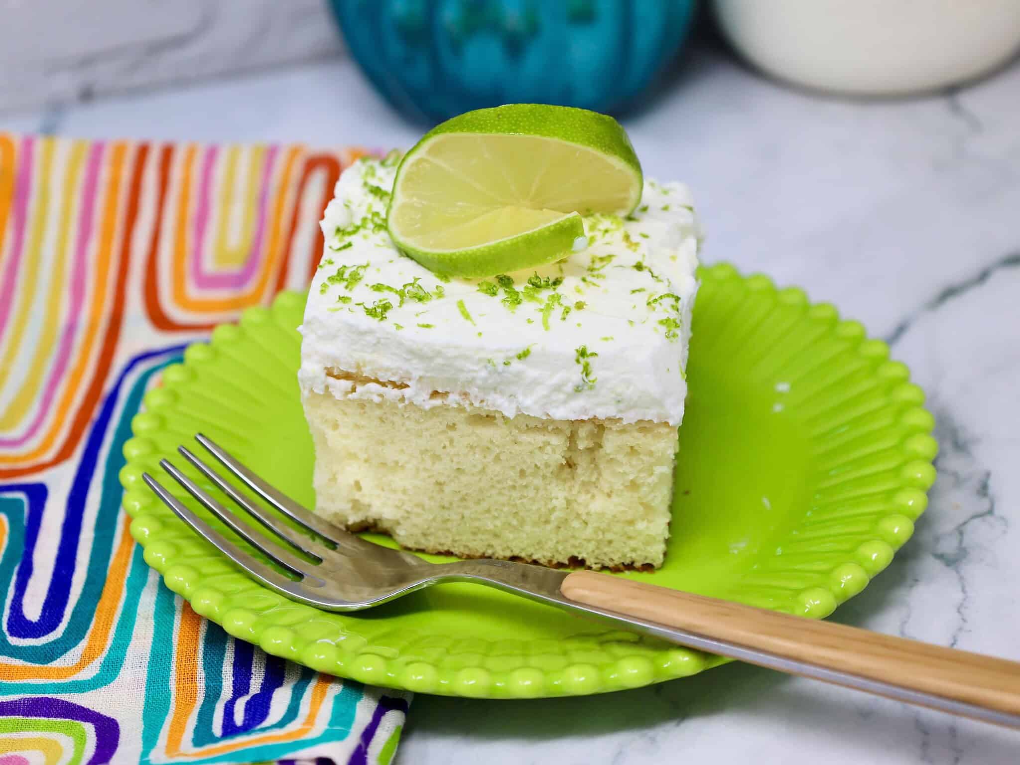 finished key lime poke cake chilled and topped with whipped cream