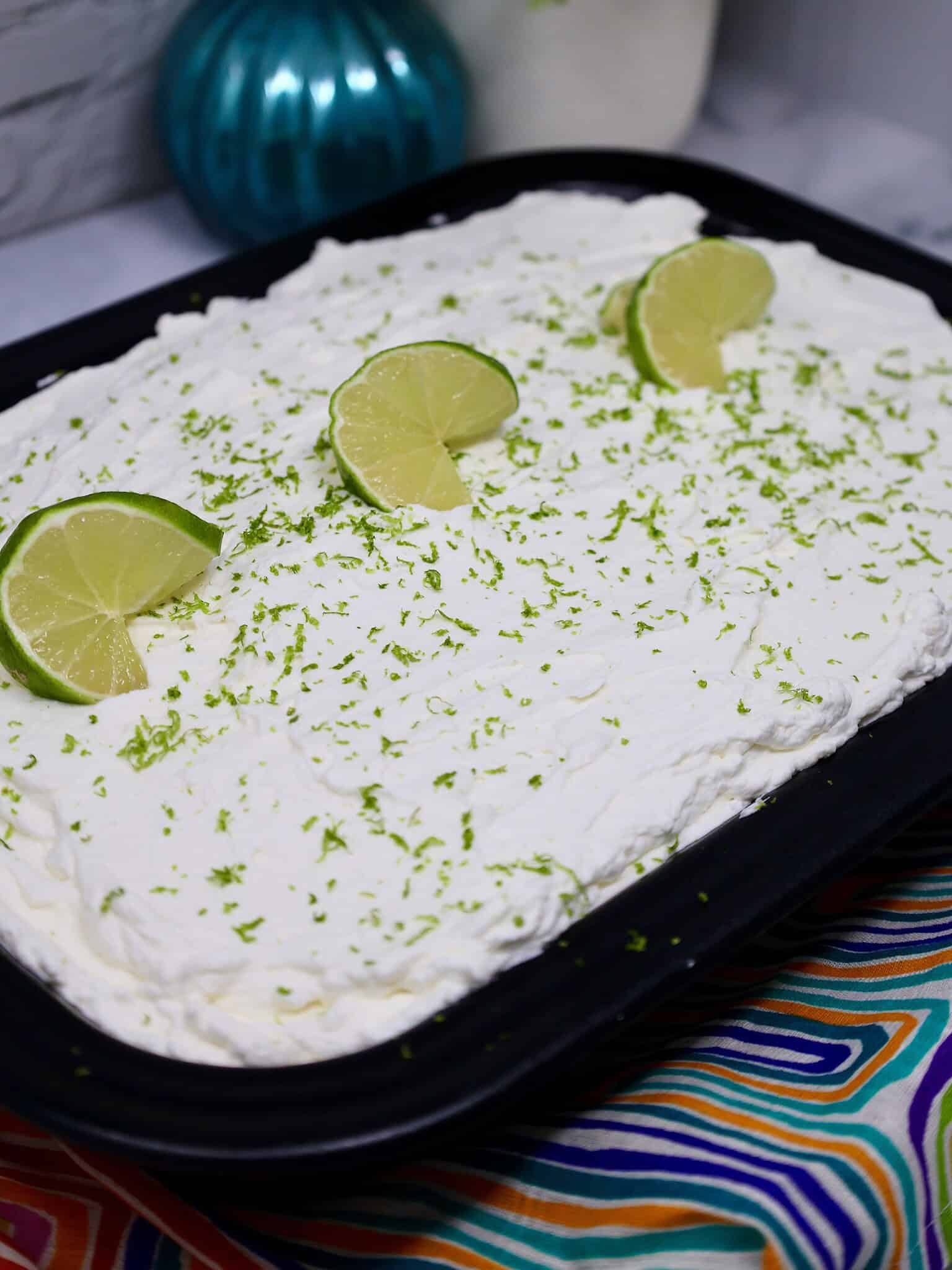 easy key lime poke cake with whipped cream topping in 9x13 pan