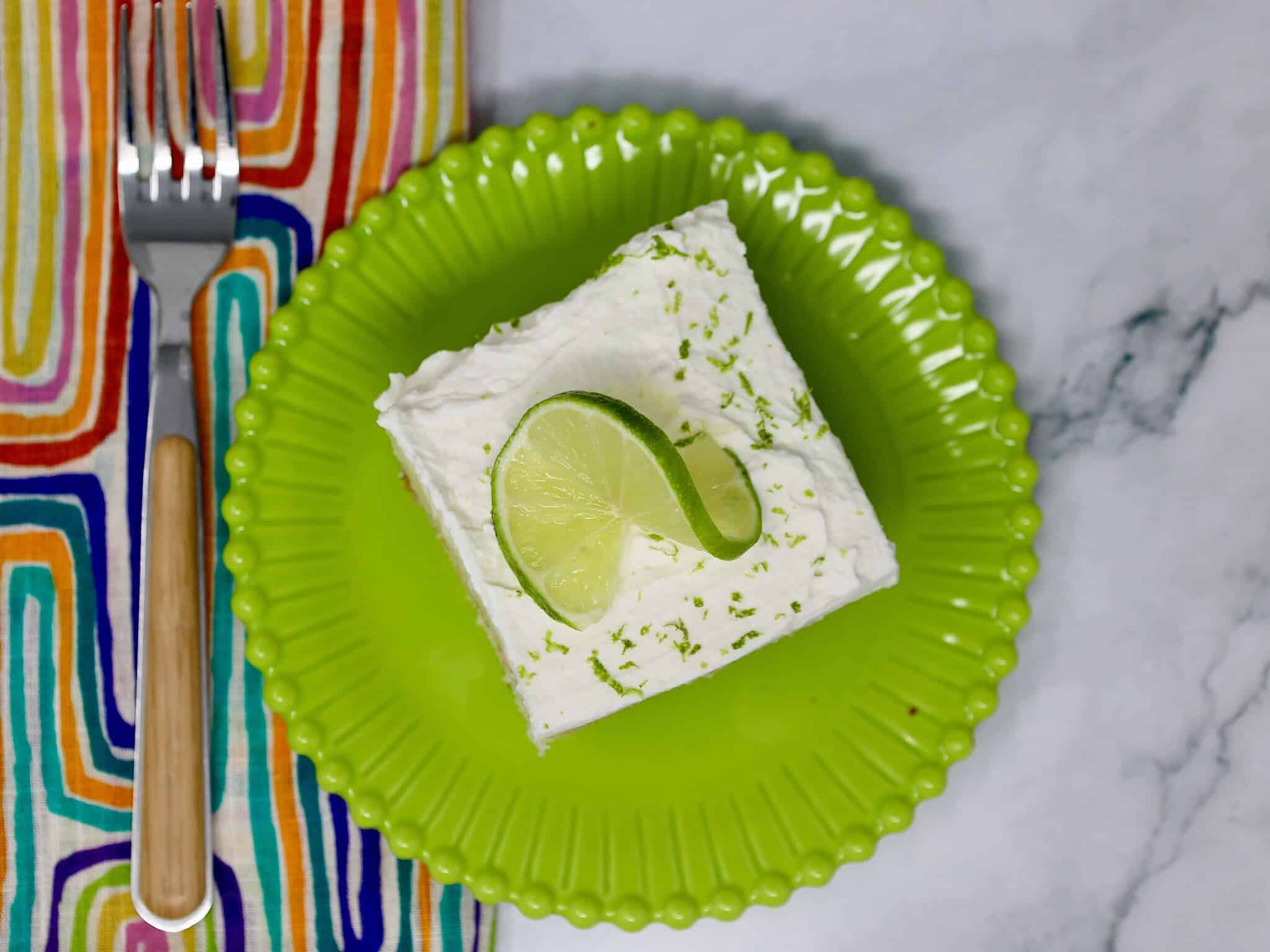 cold creamy key lime poke cake topped with homemade whipped cream