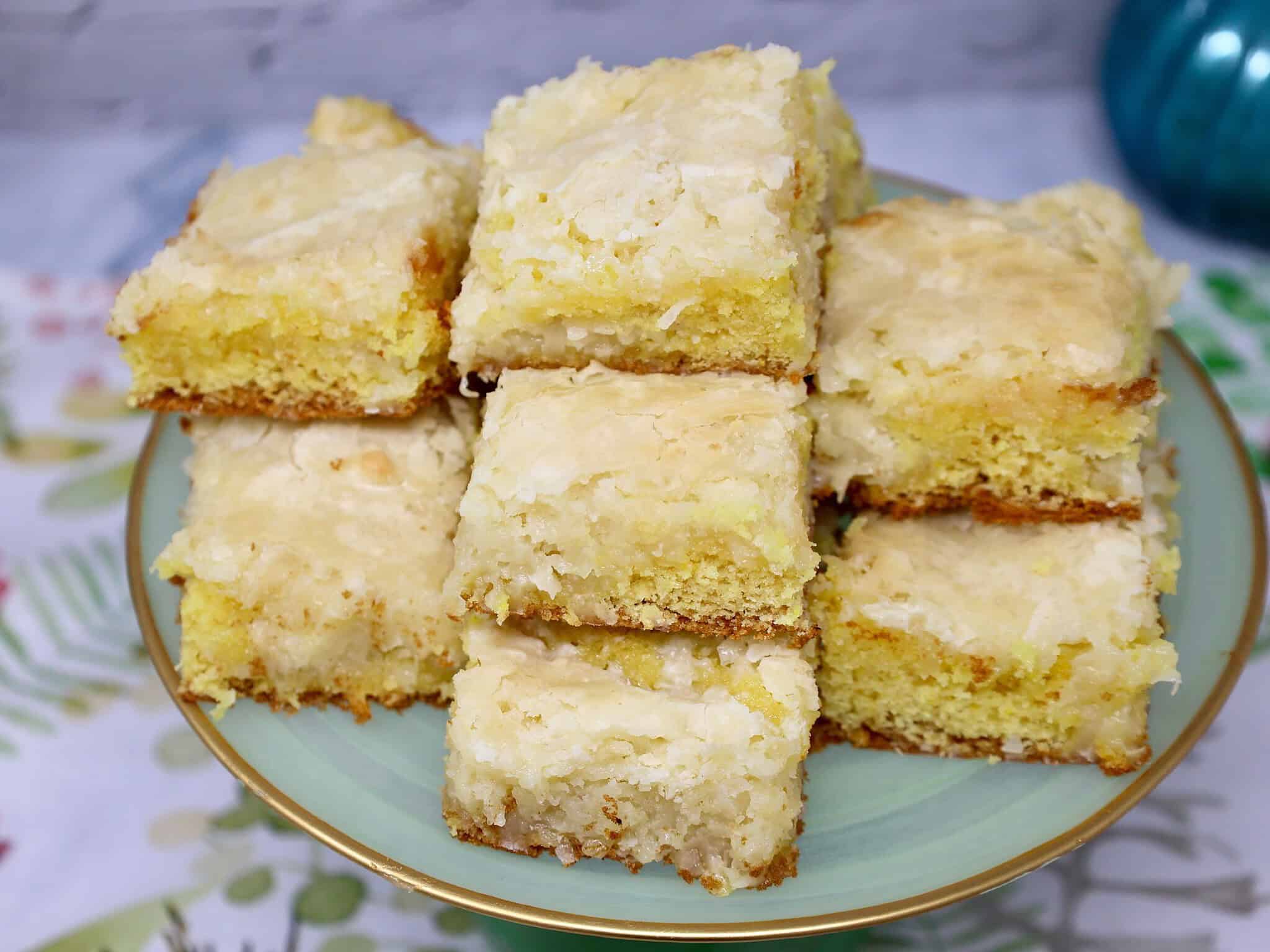 coconut lemon bars with ooey gooey filling on a pretty serving stand ready for serving at a party