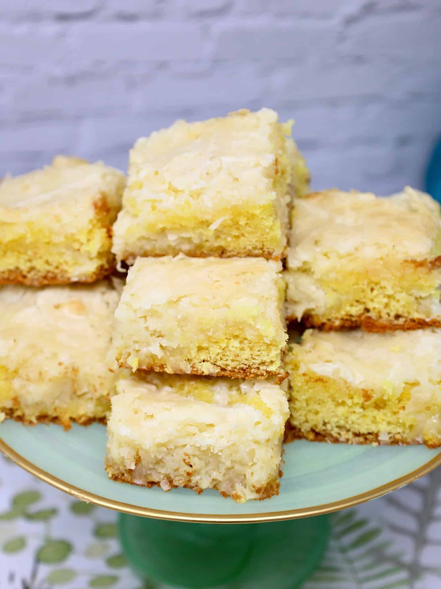 Ingredients for lemon coconut bars including lemon cake mix cream cheese powdered sugar and sweetened coconut flakes