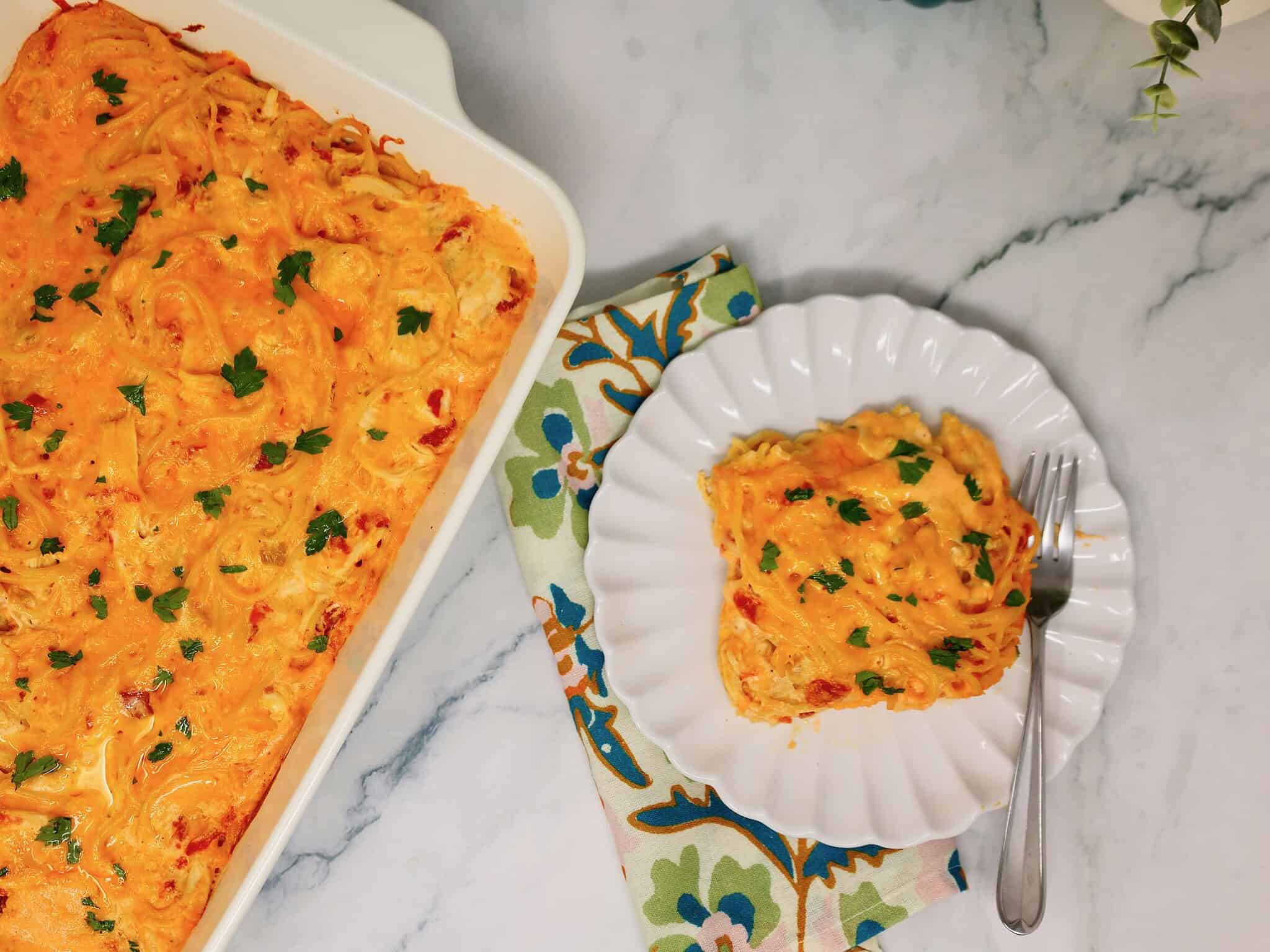 Serving of easy chicken spaghetti casserole with rotisserie chicken and rich cheese sauce