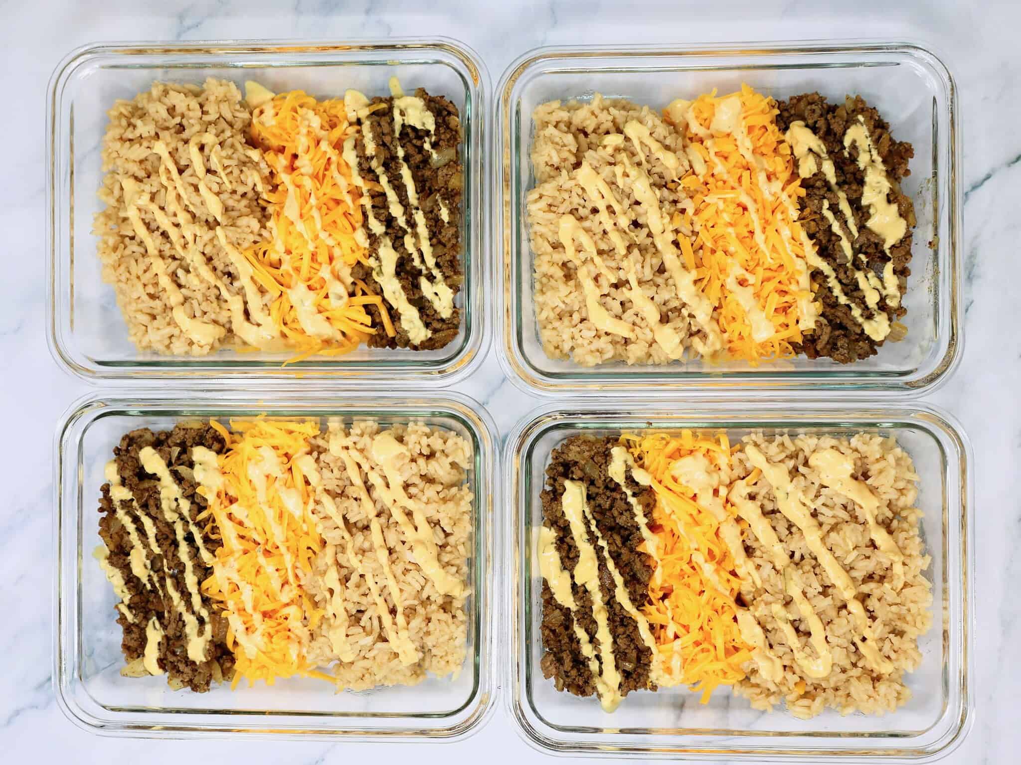 Close up of a Cheeseburger Rice Bowl with fluffy rice, seasoned beef, melted cheddar, and pickle slices