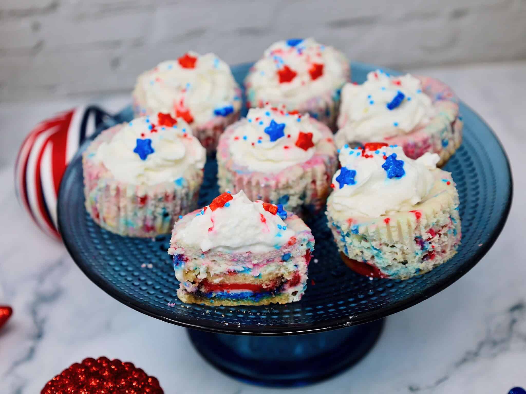 Patriotic cheesecake cups with Golden Oreo crust, whipped cream, strawberries, blueberries, and sprinkles