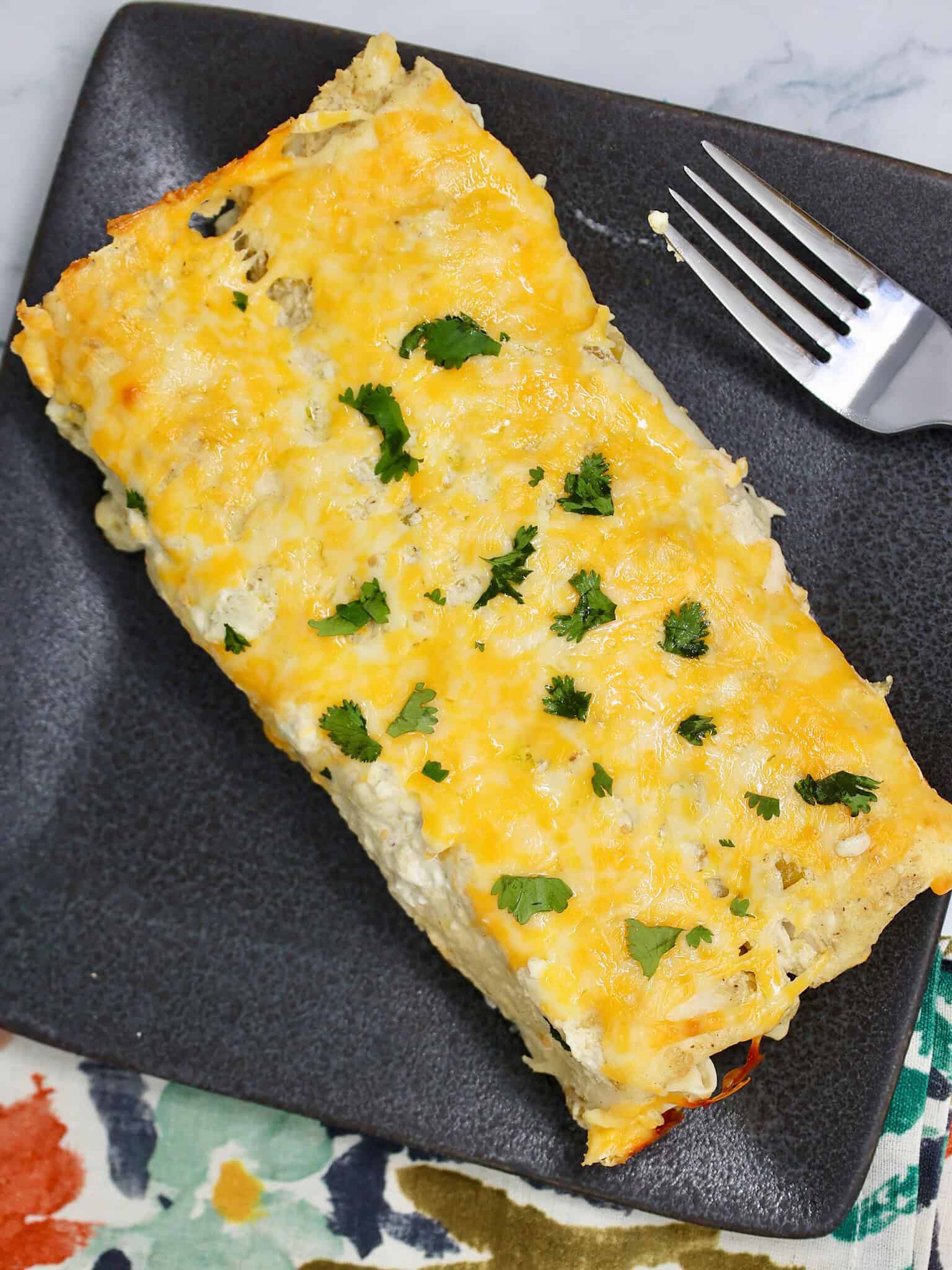 Single serving of salsa verde chicken enchiladas on a dinner plate