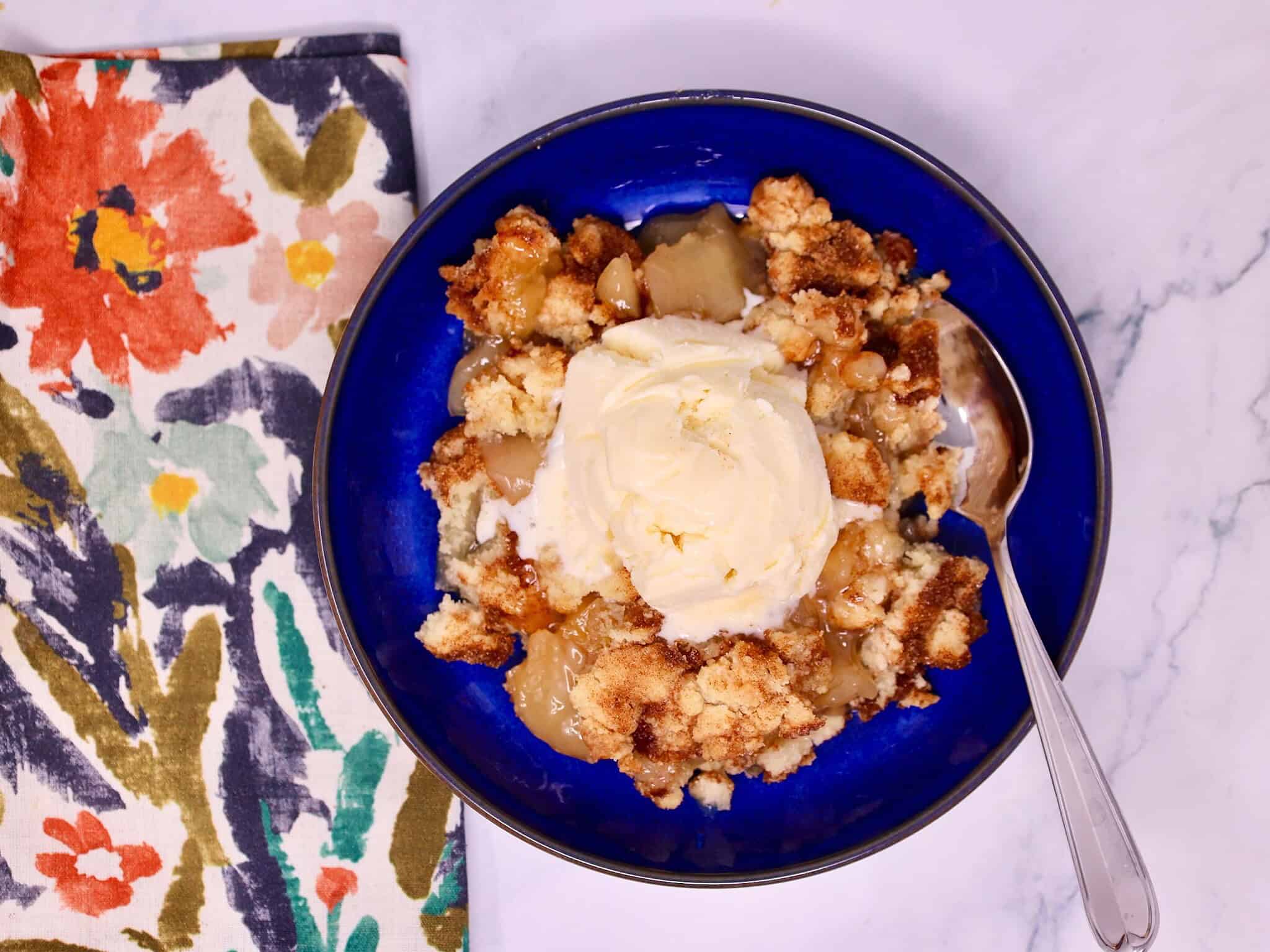 Warm snickerdoodle apple crisp made with apple pie filling, cookie mix, and melted butter.