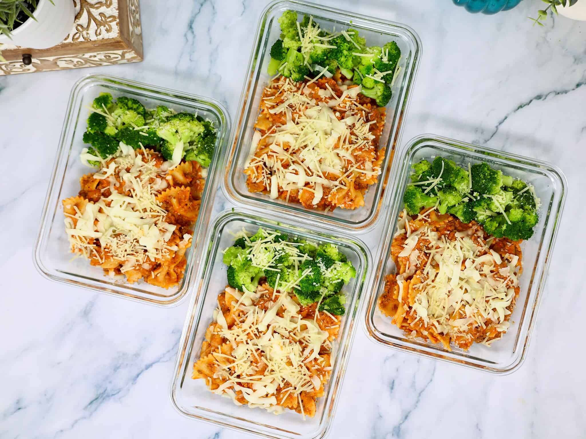 Creamy beef bowtie pasta divided into four meal prep containers