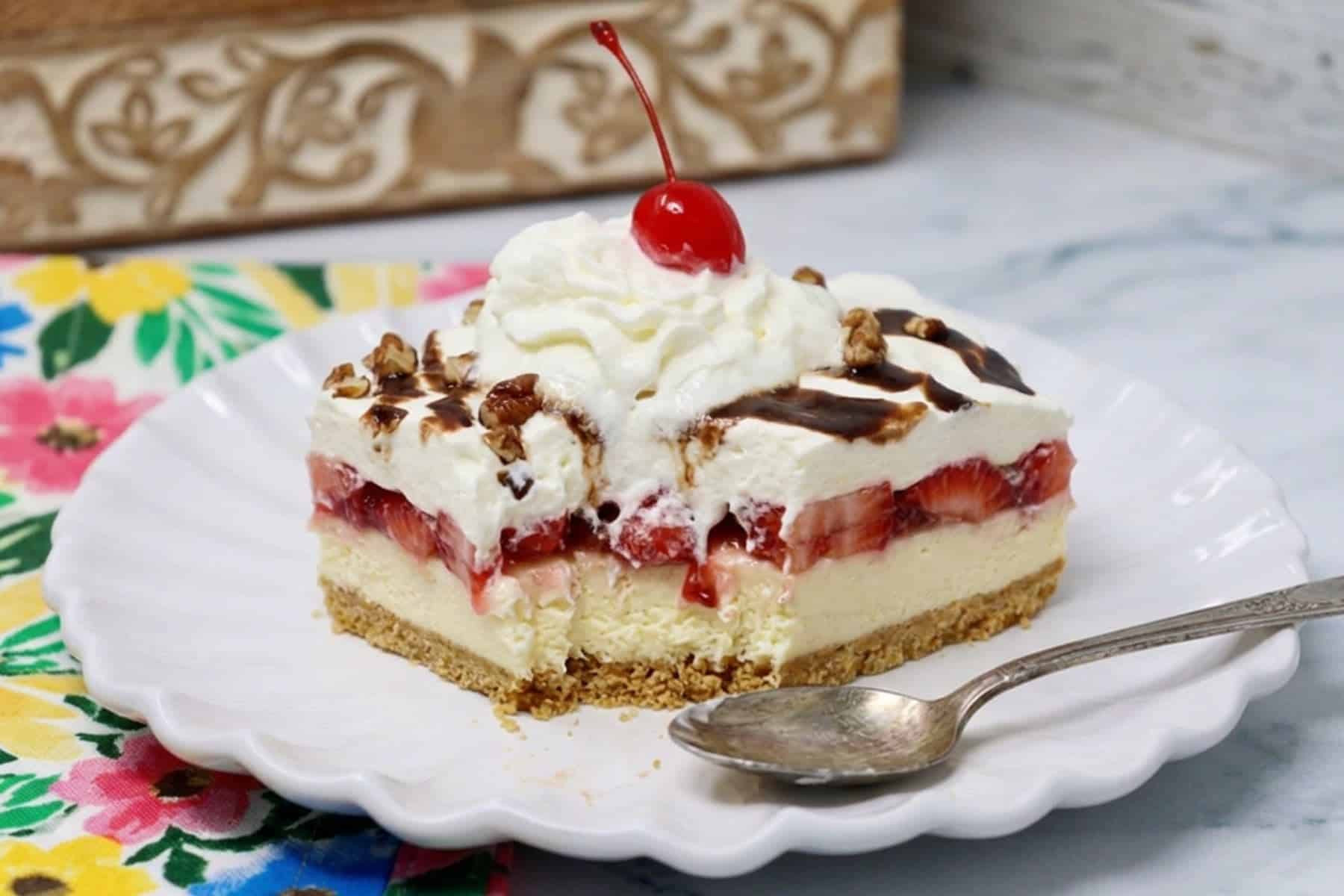 Banana Split Delight with whipped topping, sliced strawberries, chocolate syrup, and chopped nuts