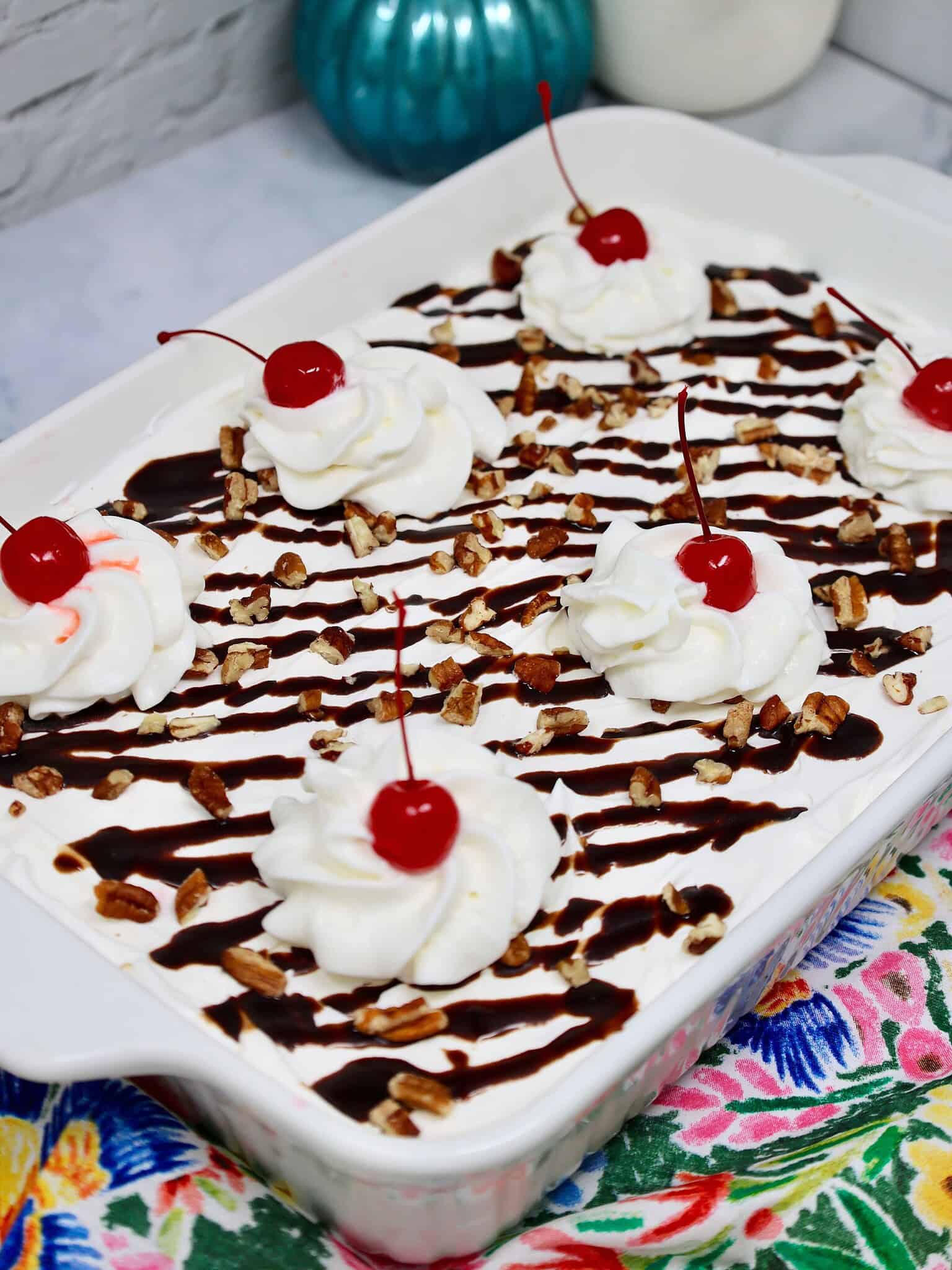 Banana Split Delight with whipped topping, sliced strawberries, chocolate syrup, and chopped nuts