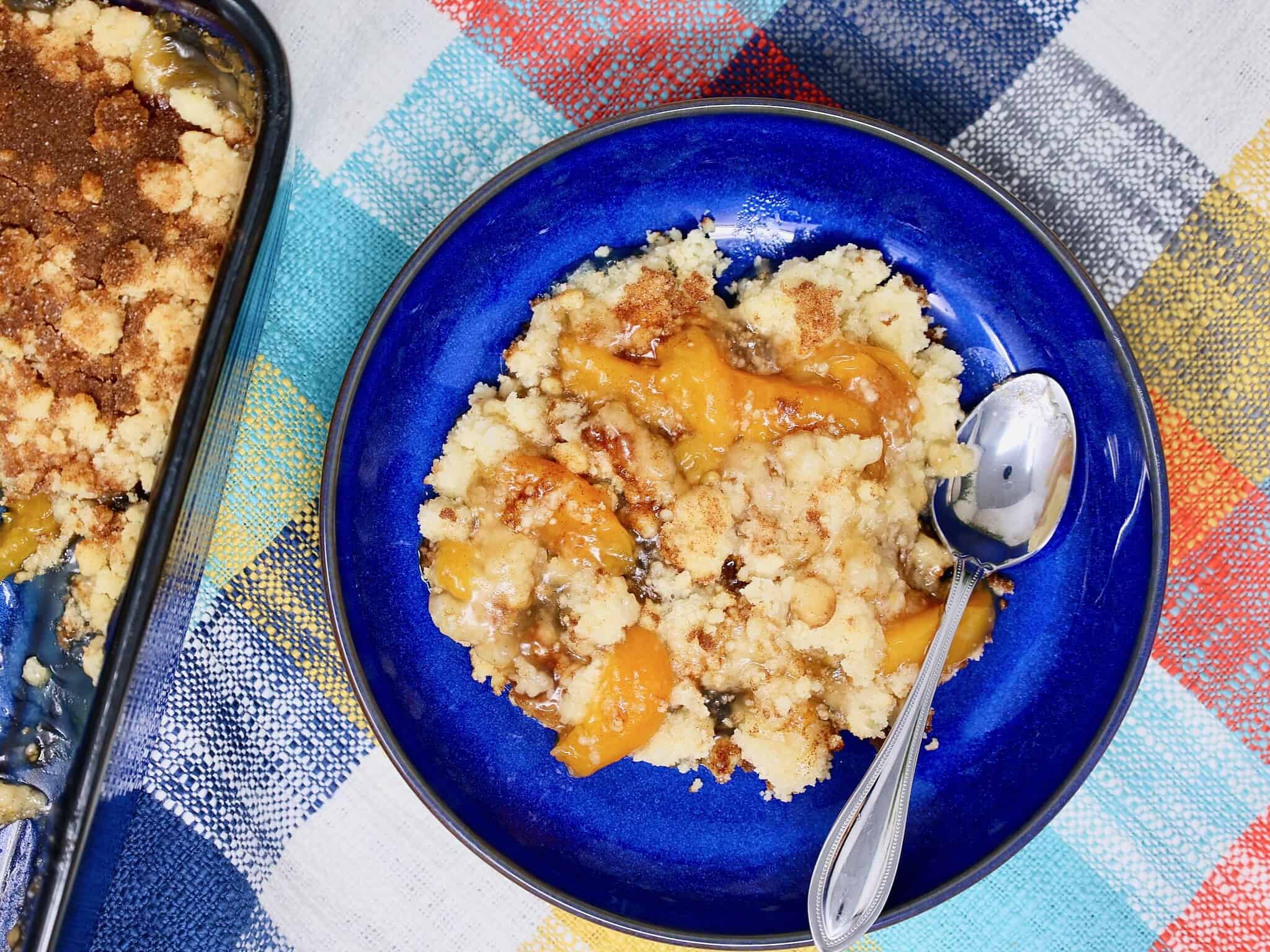Freshly baked peach crisp with golden brown topping