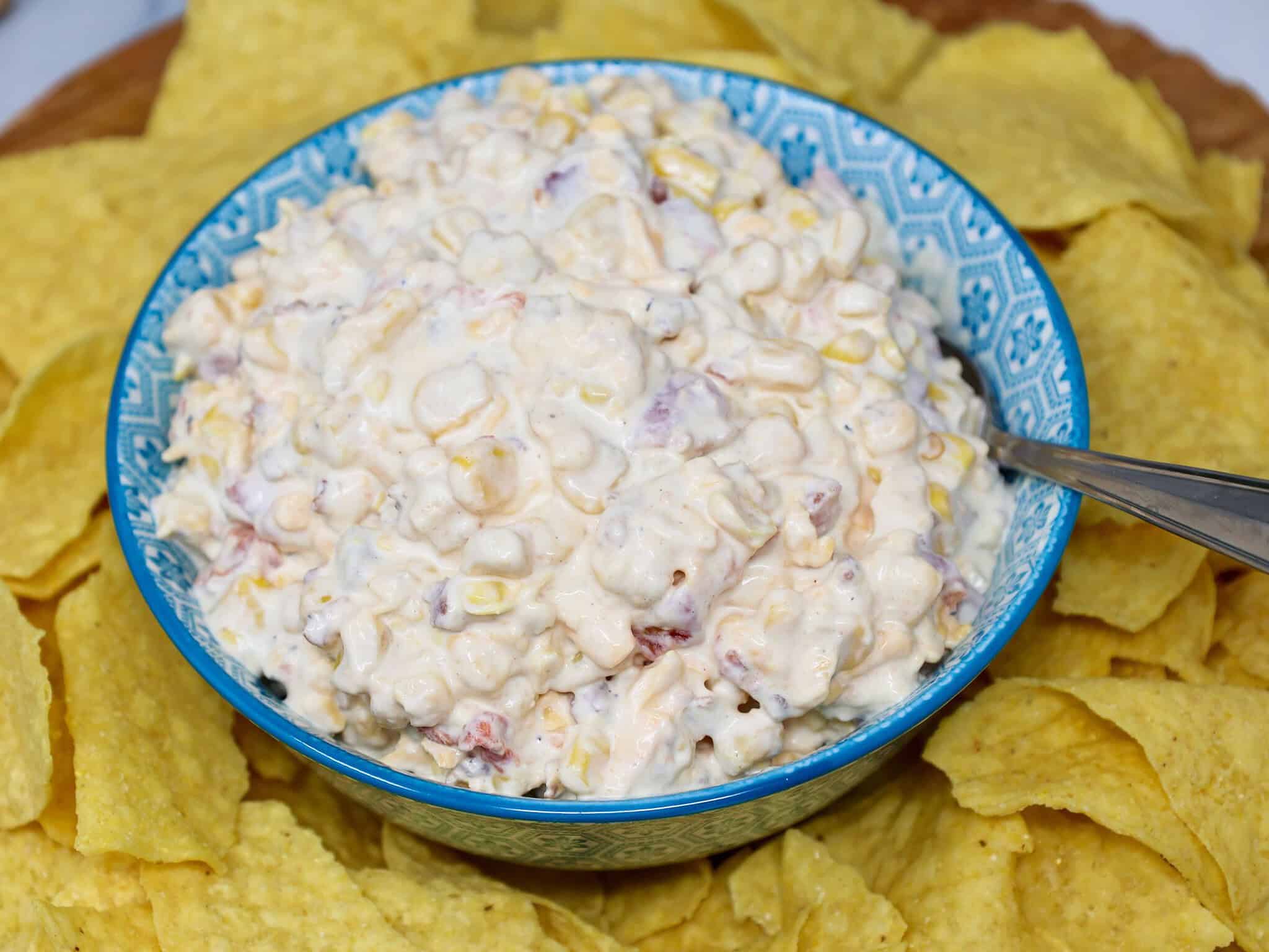 Creamy cold corn dip with Rotel, bacon, cheddar cheese, and green onions