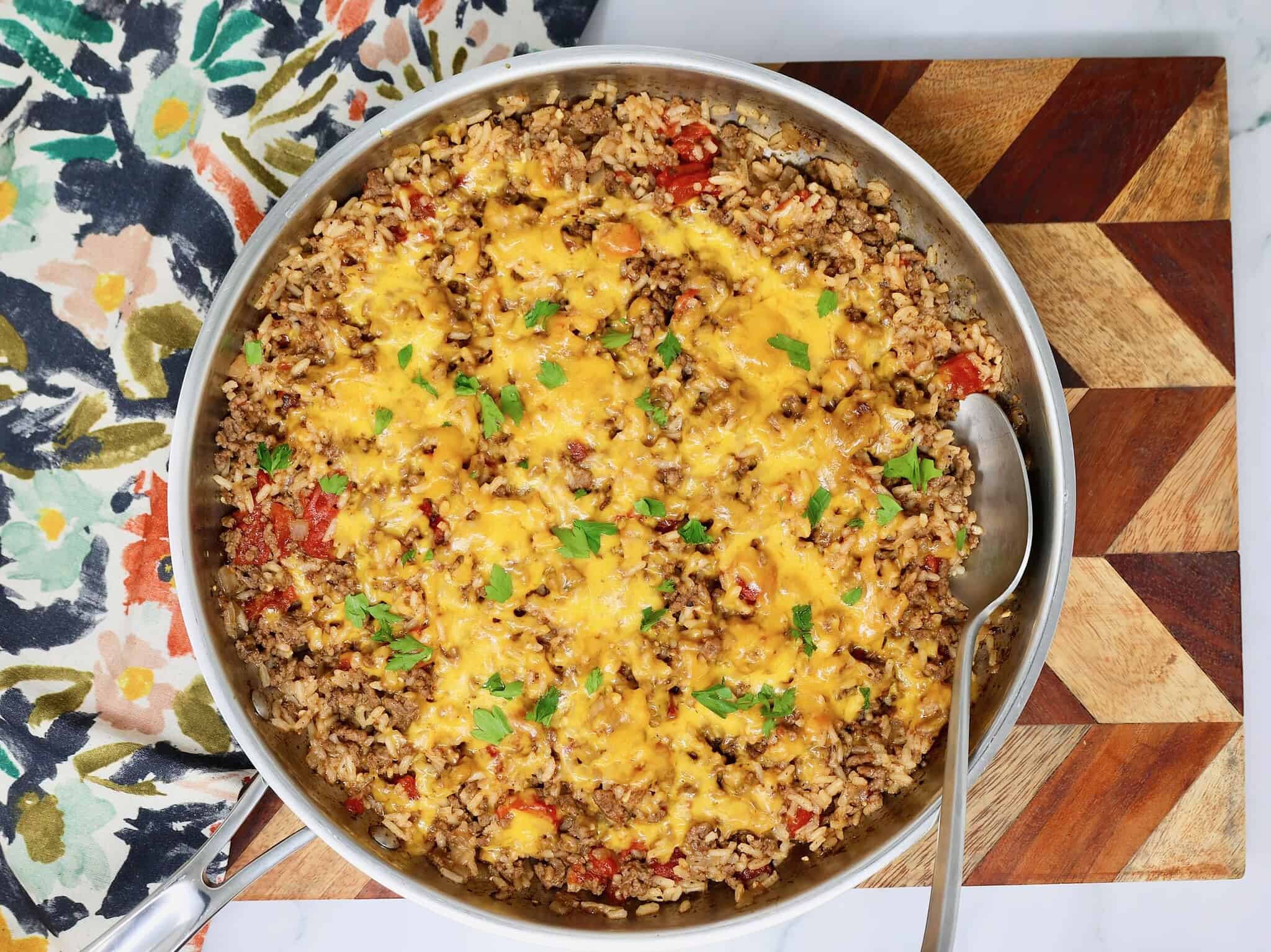 Cheesy ground beef and rice served from a skillet for an easy dinner