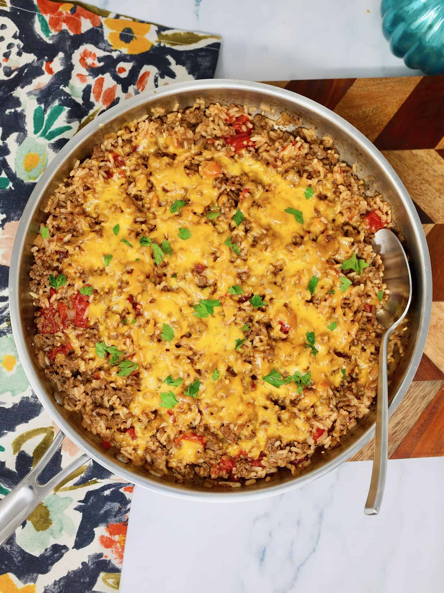 Finished cheesy beef and rice dinner served in a large skillet