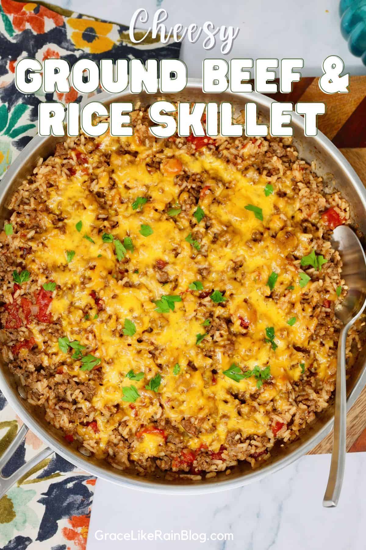 Cheesy ground beef and rice skillet with tomatoes and melted cheddar cheese