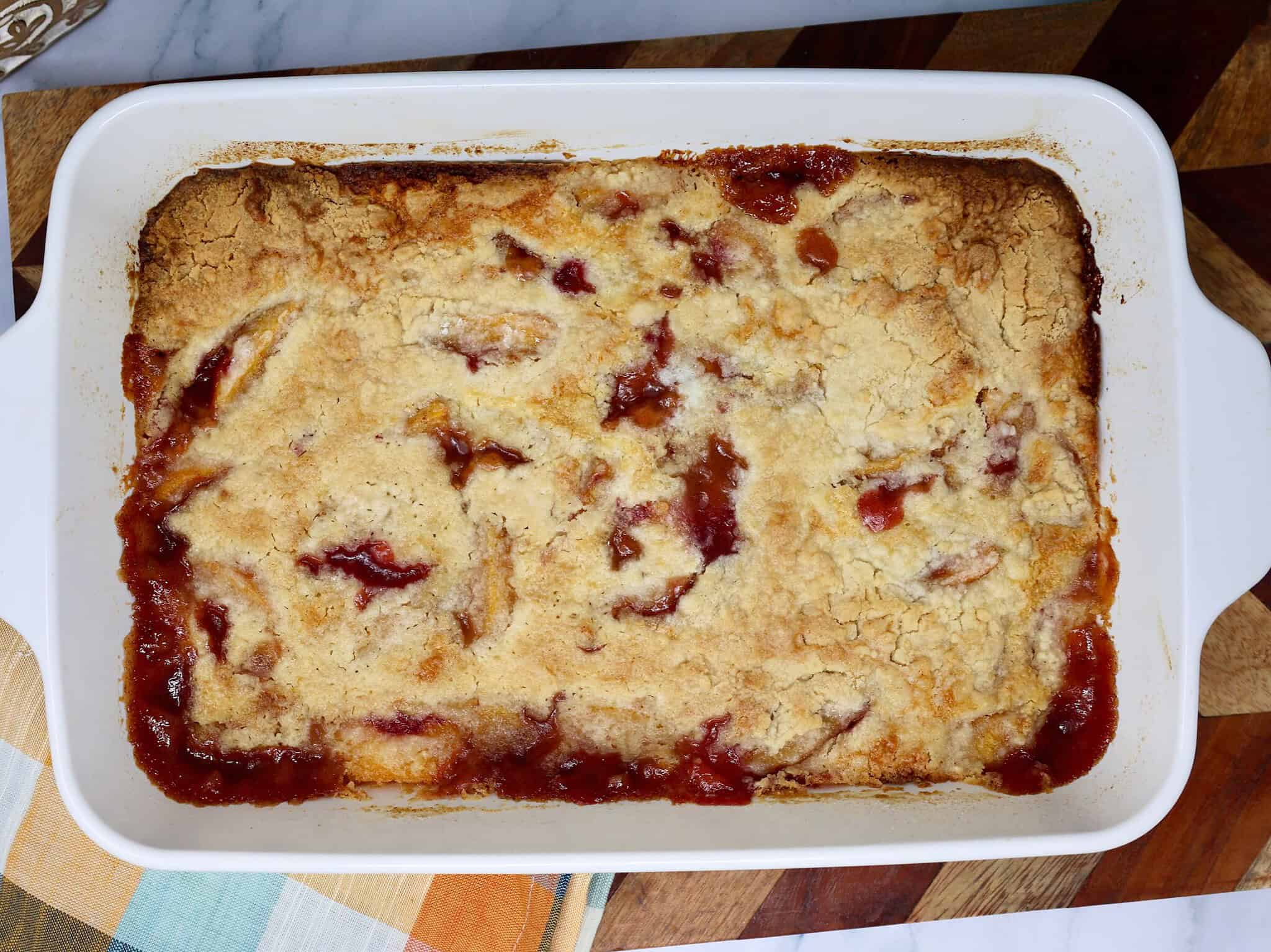Easy Fresh Peach Dump Cake served warm in a white baking dish