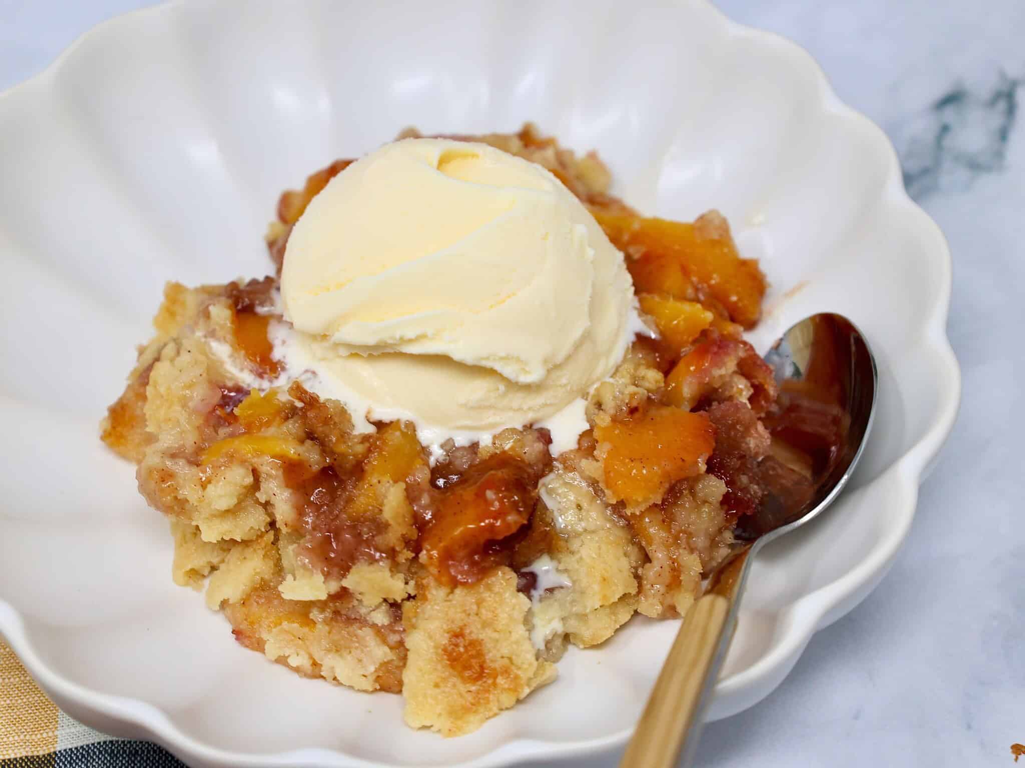 Easy summer peach dessert served with a scoop of vanilla ice cream