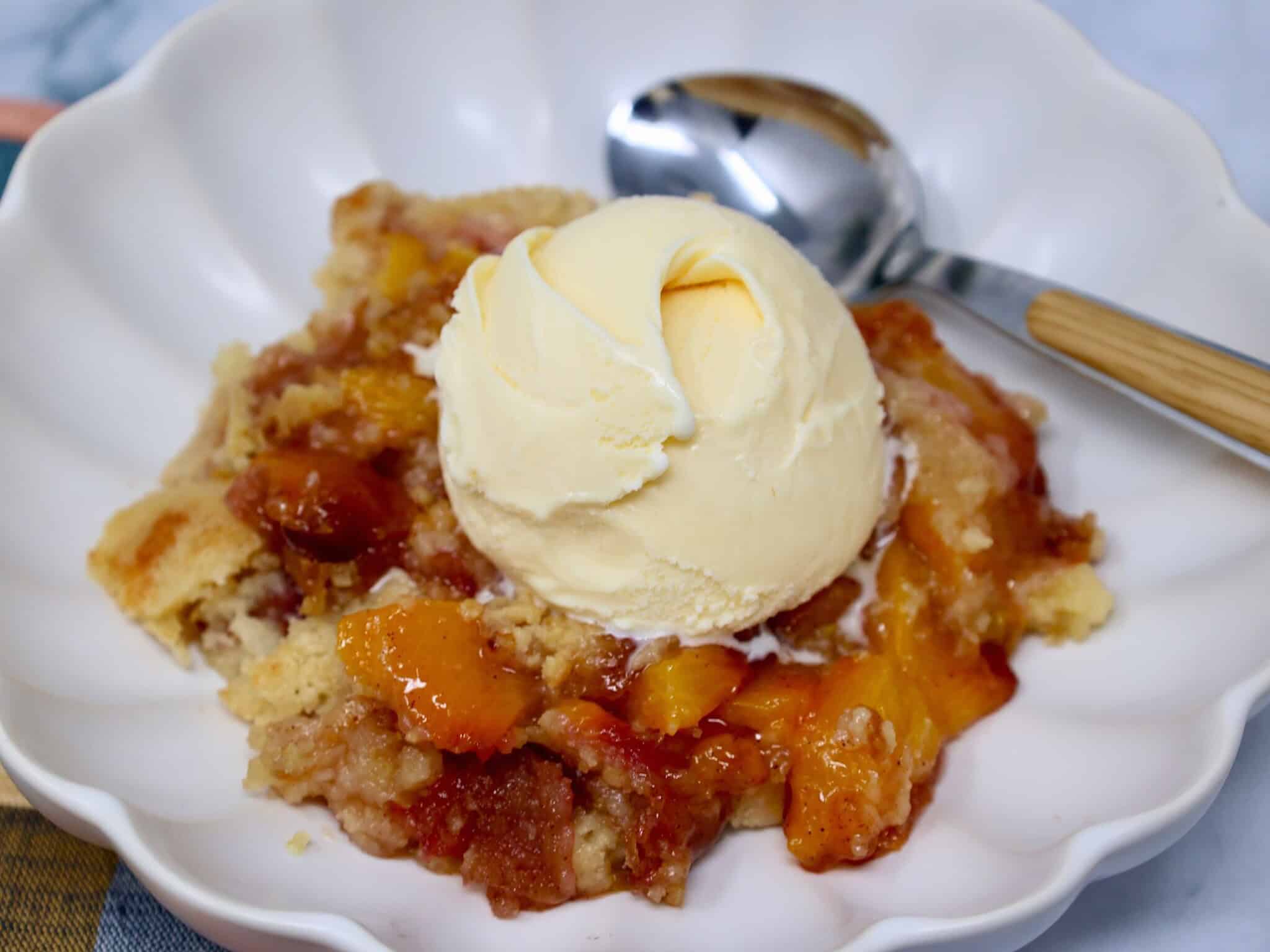 Warm peach dump cake with fresh peaches and vanilla cake mix