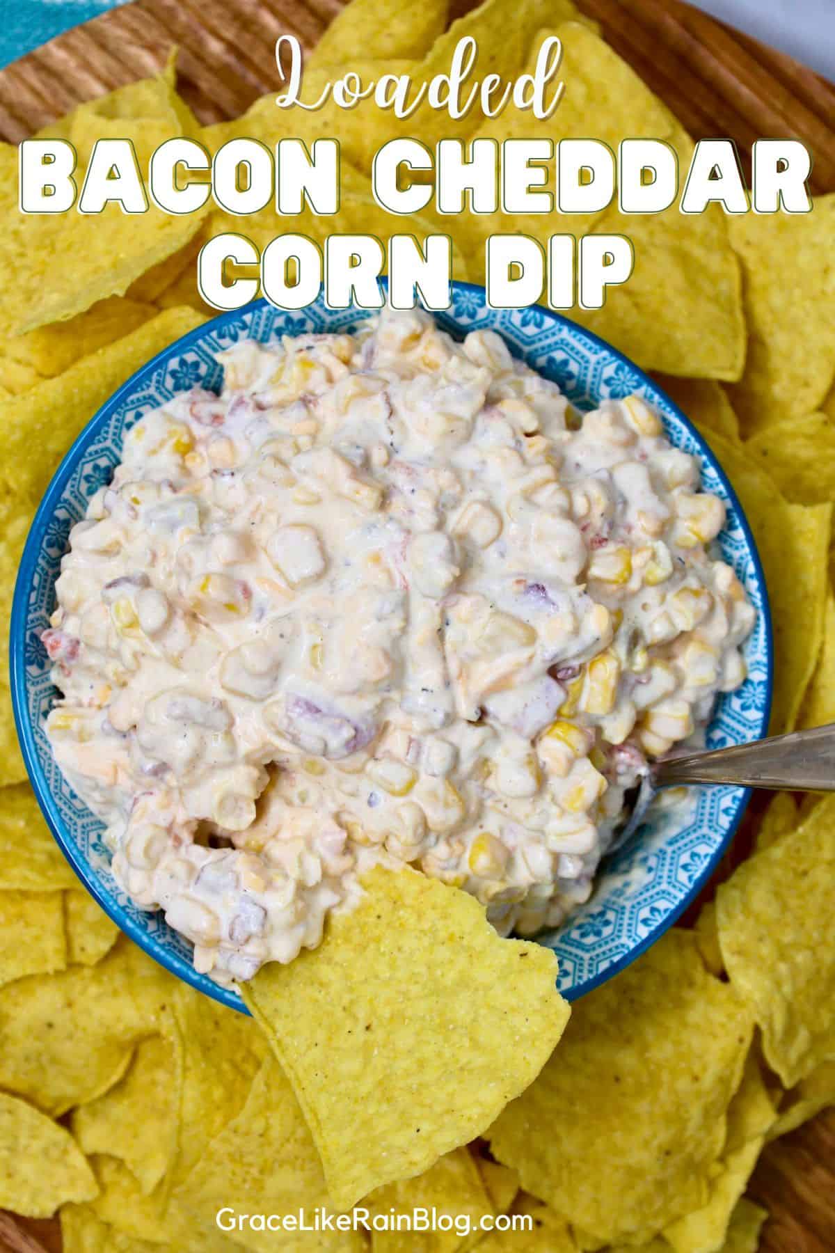Loaded Bacon Cheddar Corn Dip topped with crumbled bacon, shredded cheddar cheese, and sliced green onions