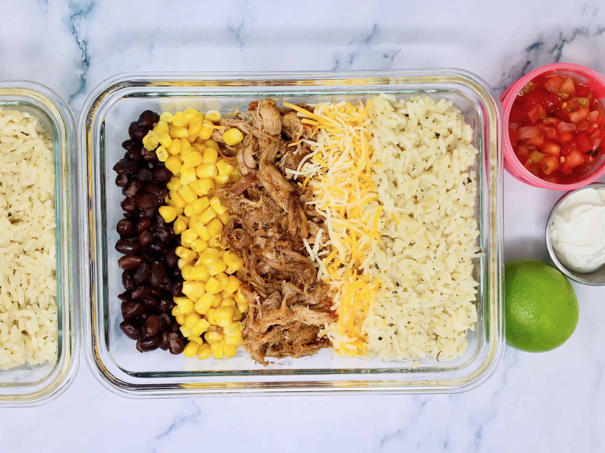 Overhead view of four Mexican pulled pork burrito bowls for easy meal prep