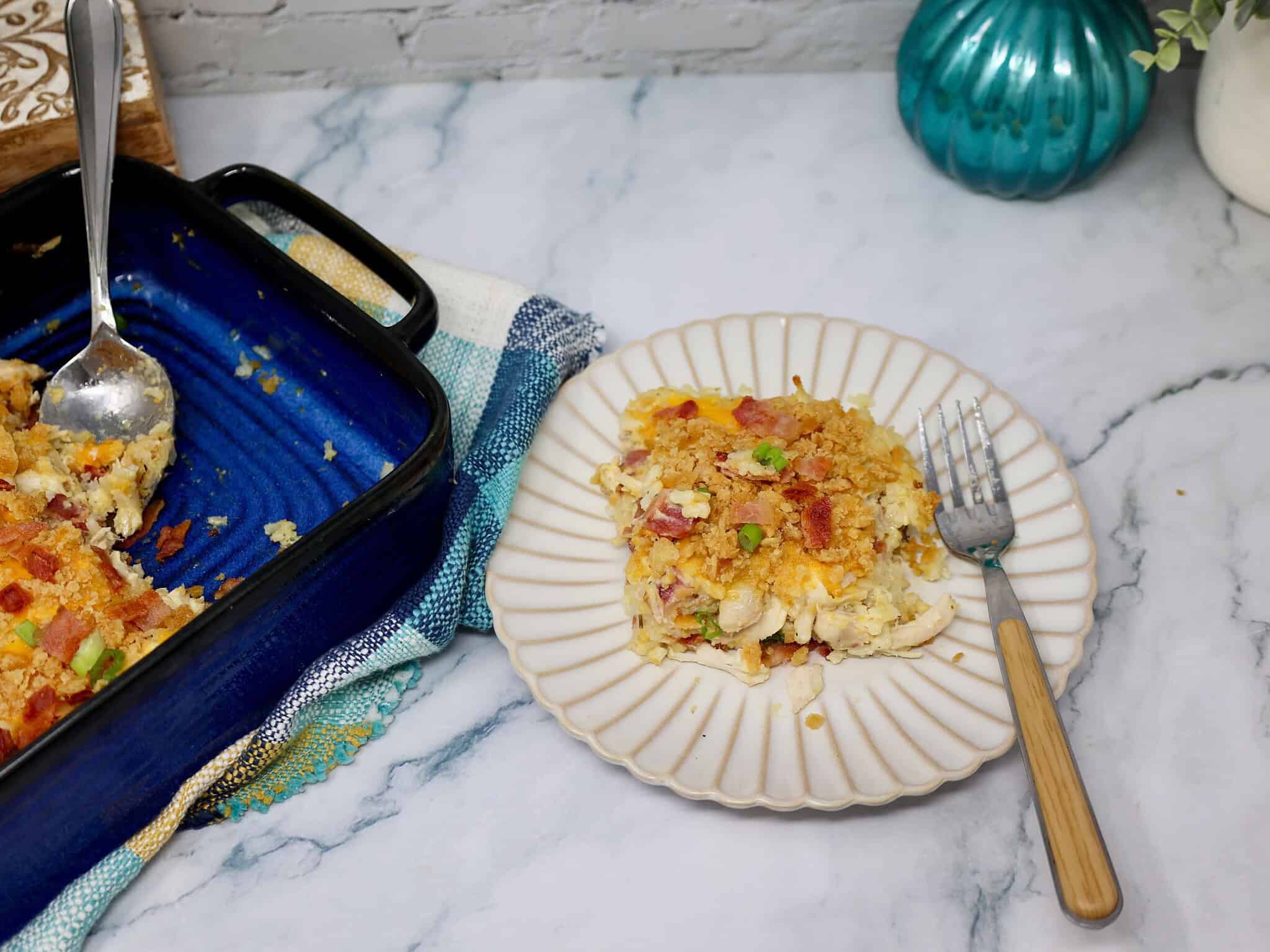Serving of creamy rotisserie chicken bacon ranch rice casserole on a dinner plate.