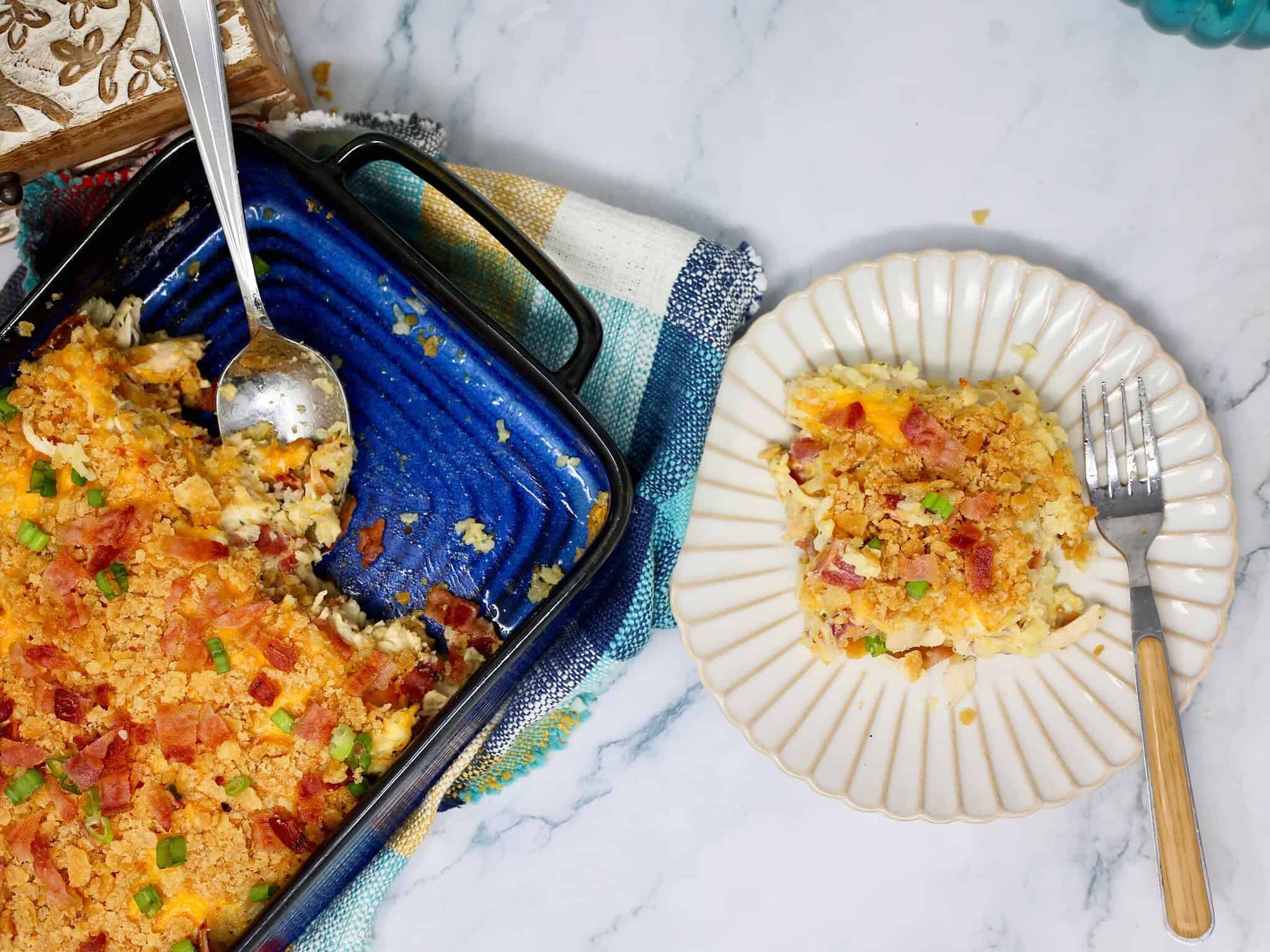 a serving of creamy chicken bacon ranch rice casserole with rotisserie chicken and crispy cracker topping.